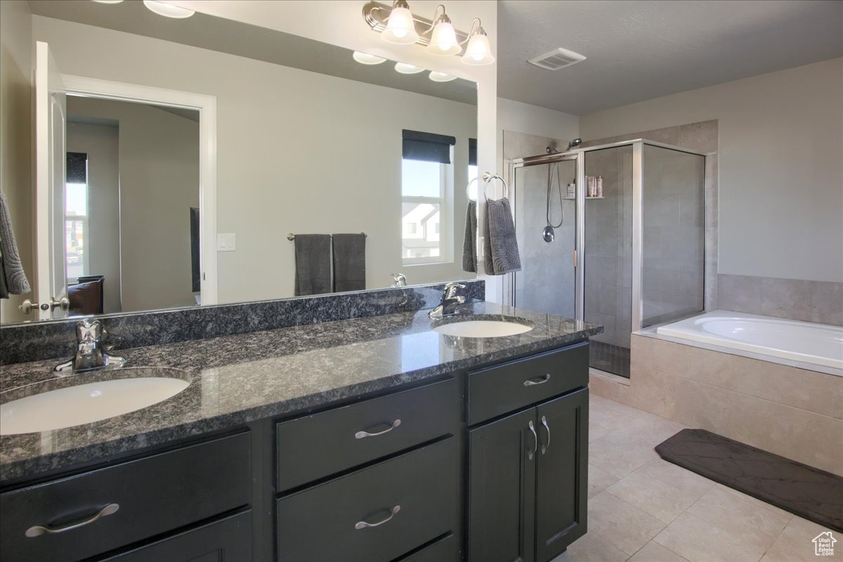 Bathroom with vanity, independent shower and bath, and tile patterned flooring