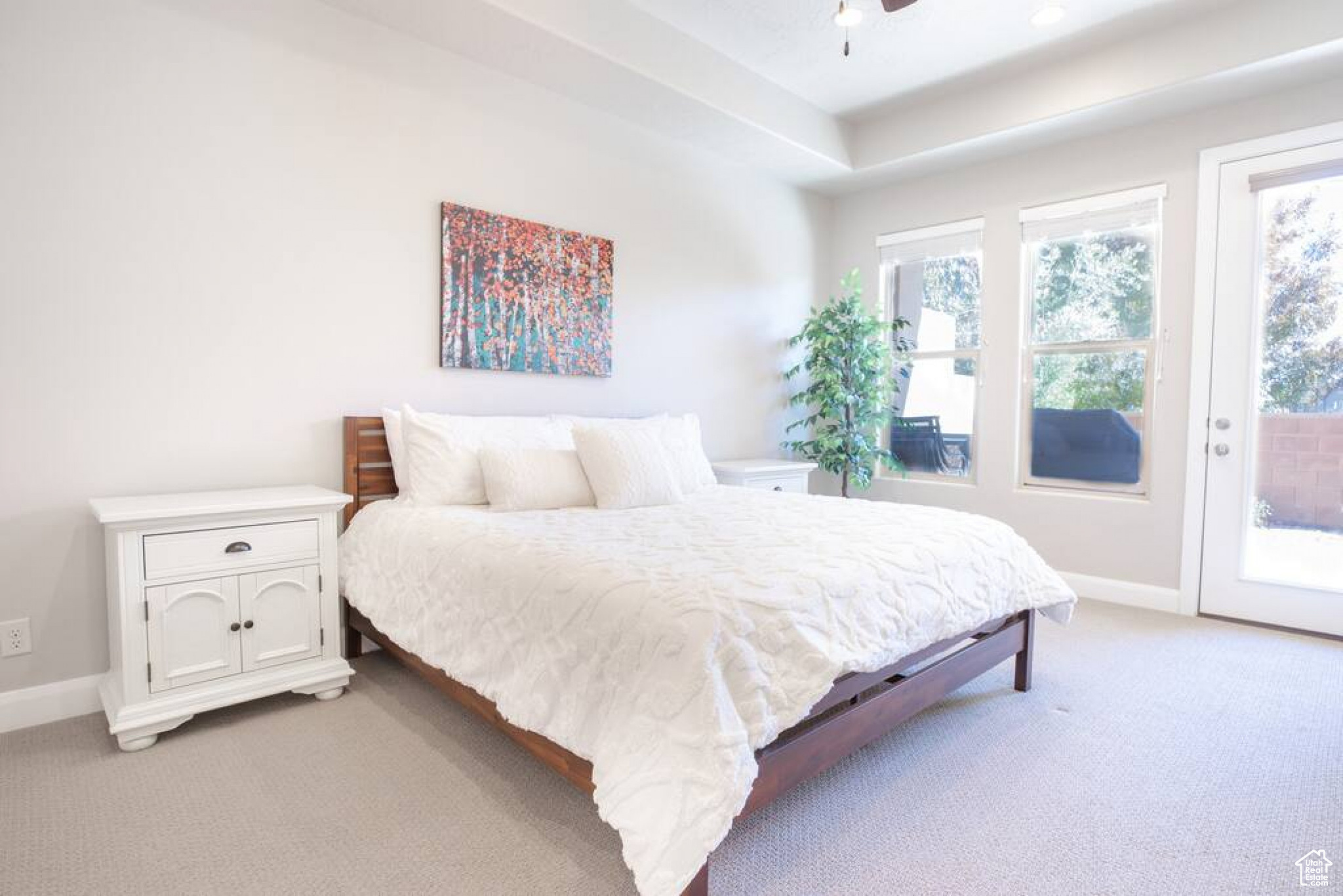 Master Bedroom with ceiling fan, access to exterior, light carpet, and multiple windows