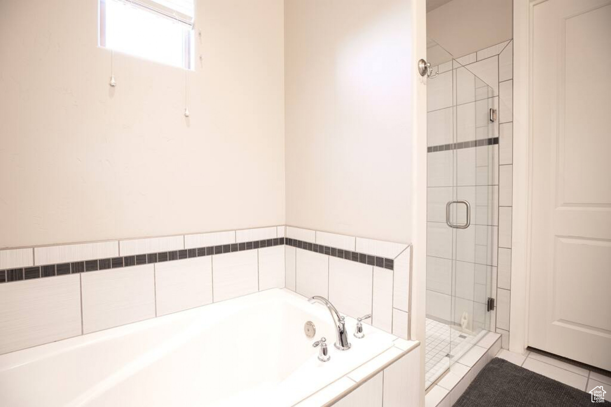 Bathroom featuring plus walk in shower and tile patterned flooring