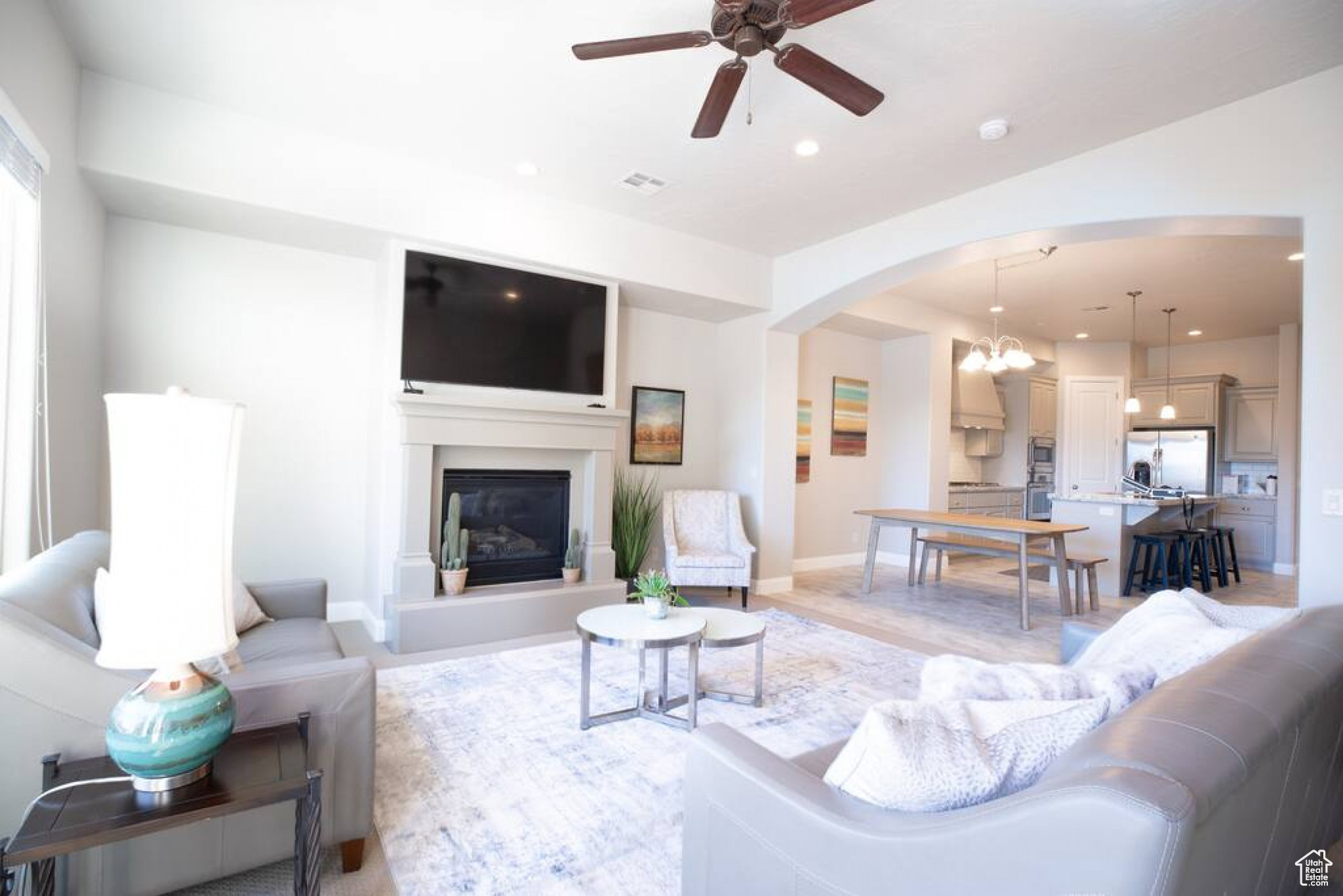 Living room featuring ceiling fan with stunning fireplace