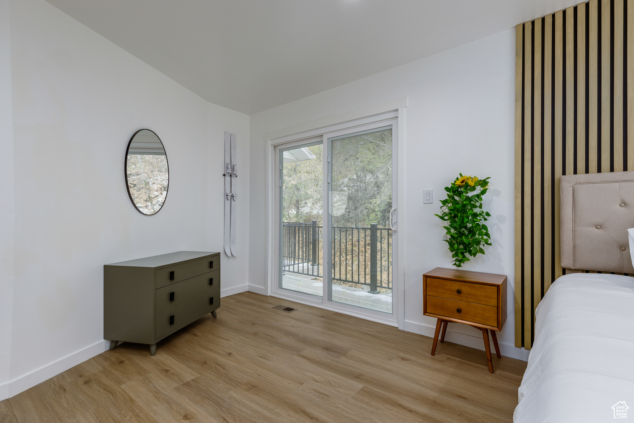 Bedroom with access to exterior and light hardwood / wood-style floors