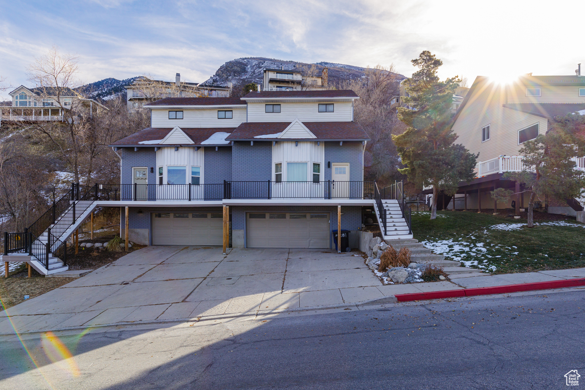 View of front of home with a mountain view and a garage