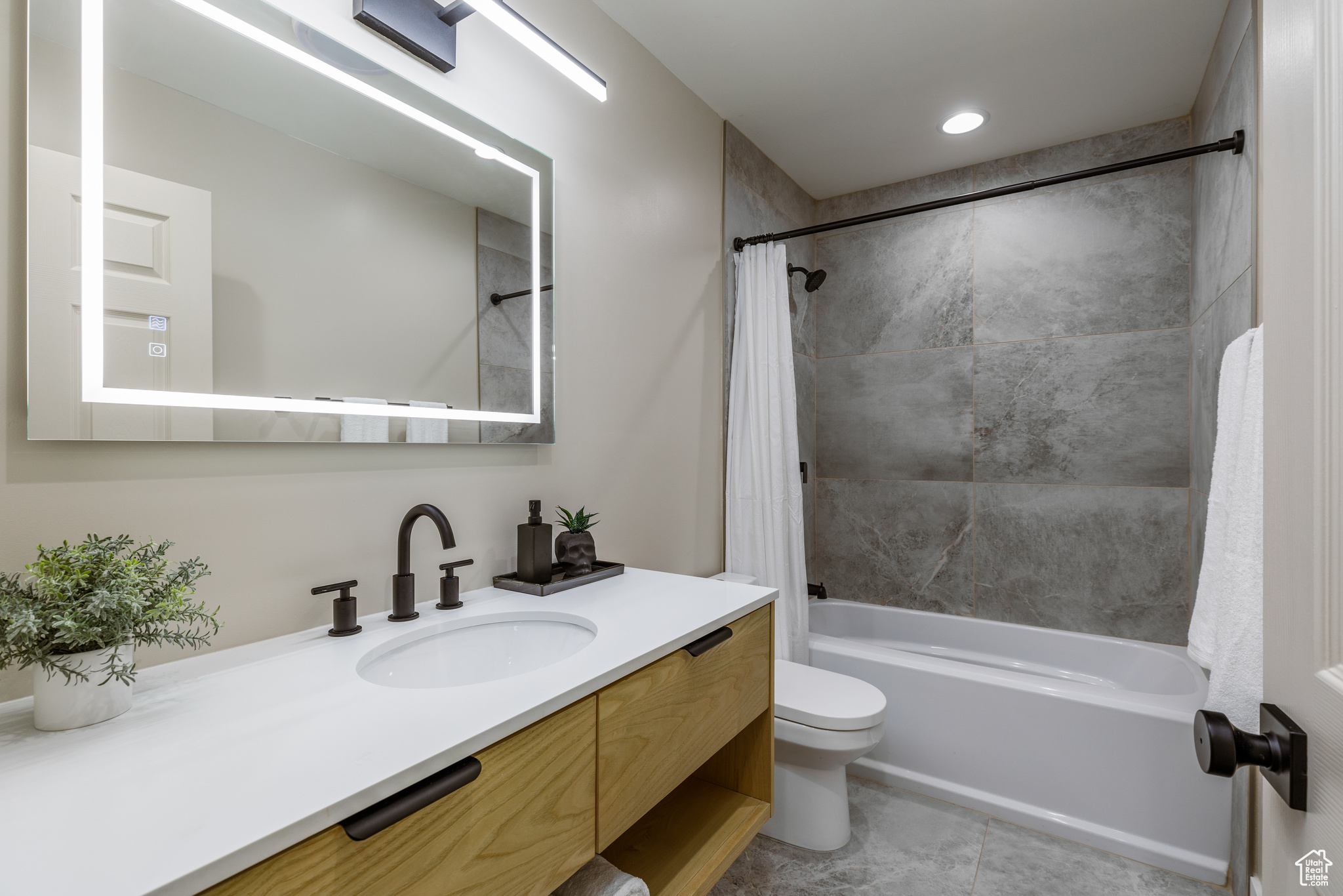 Full bathroom with vanity, toilet, and shower / bath combo