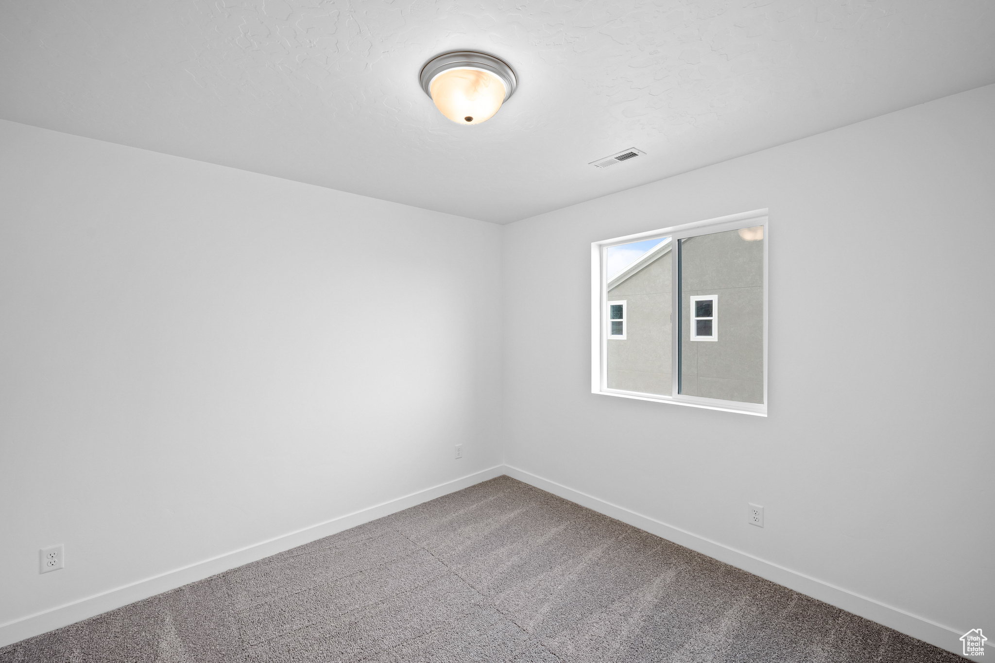 Empty room with carpet floors