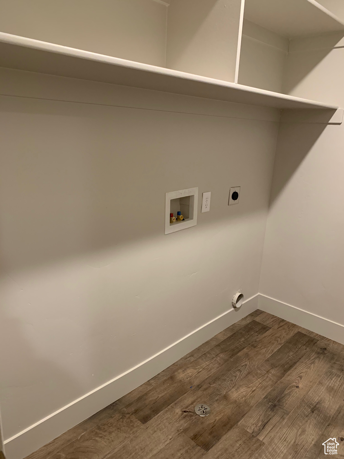 Clothes washing area featuring washer hookup, dark hardwood / wood-style flooring, and hookup for an electric dryer