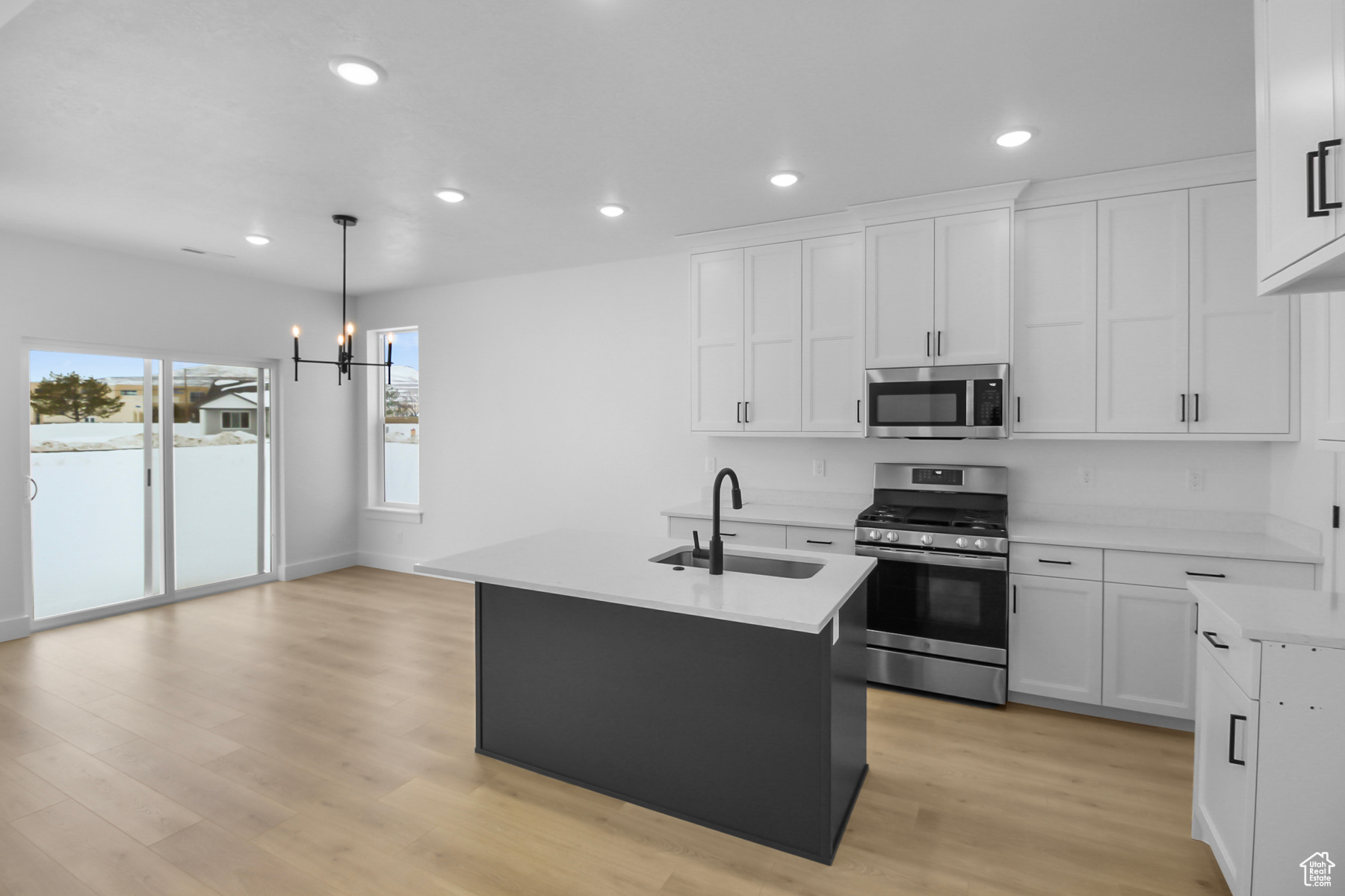 Kitchen featuring a center island with sink, and appliances with stainless steel finishes