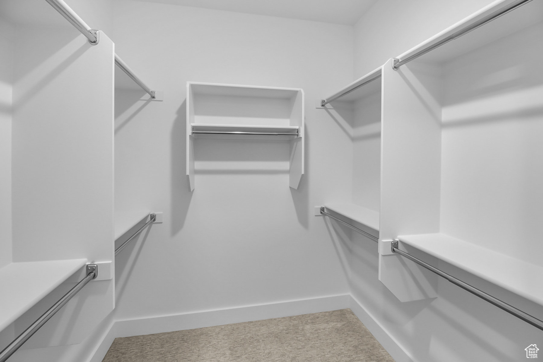 Walk in closet with carpet flooring and built in shelving