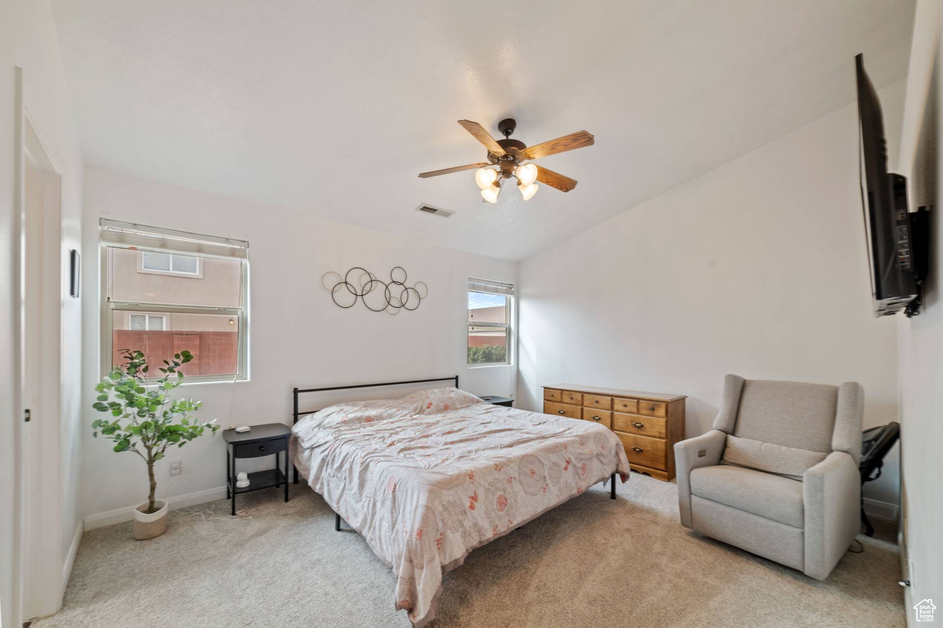 Bedroom with light carpet and ceiling fan