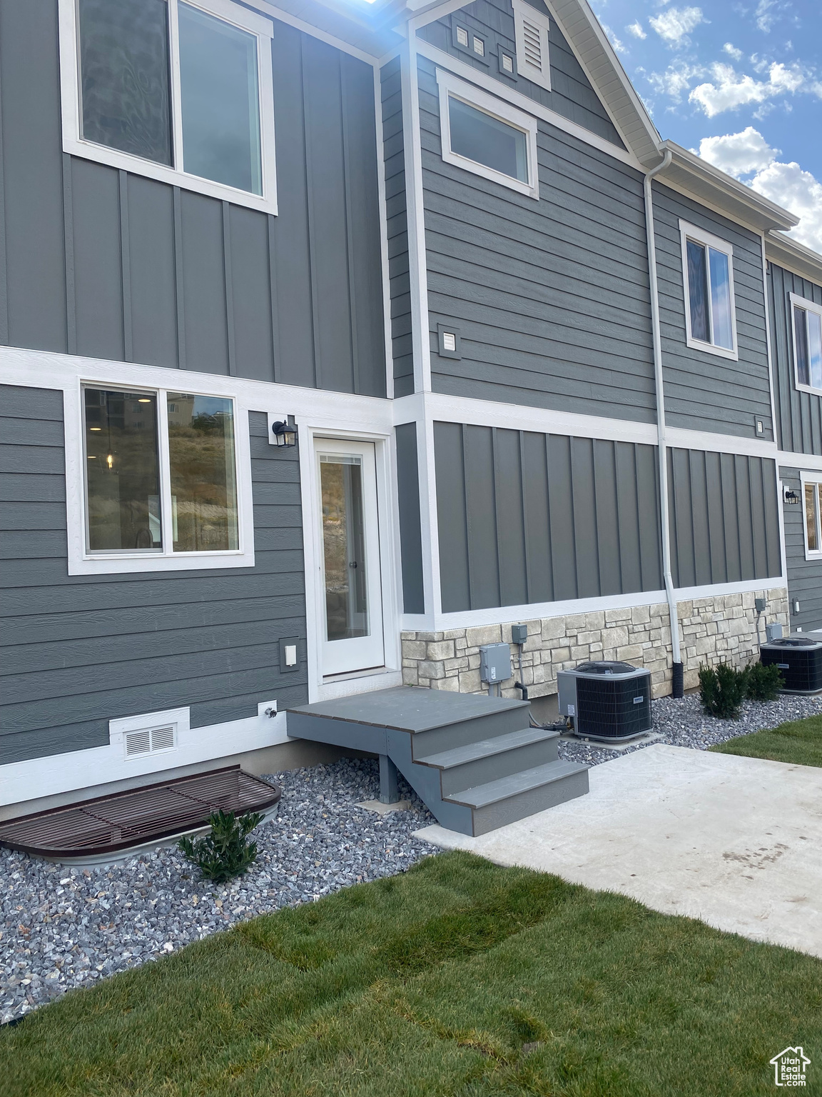 Back of property featuring cooling unit and a patio area