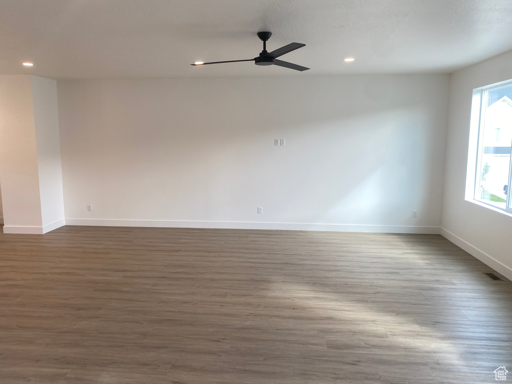 Unfurnished room with ceiling fan, hardwood / wood-style floors