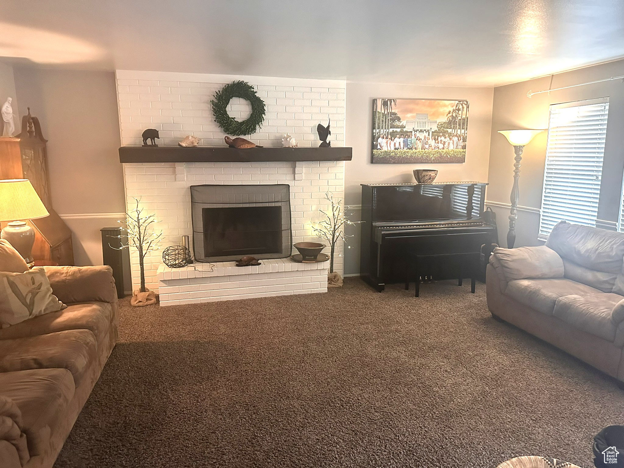 Living room featuring carpet and a fireplace