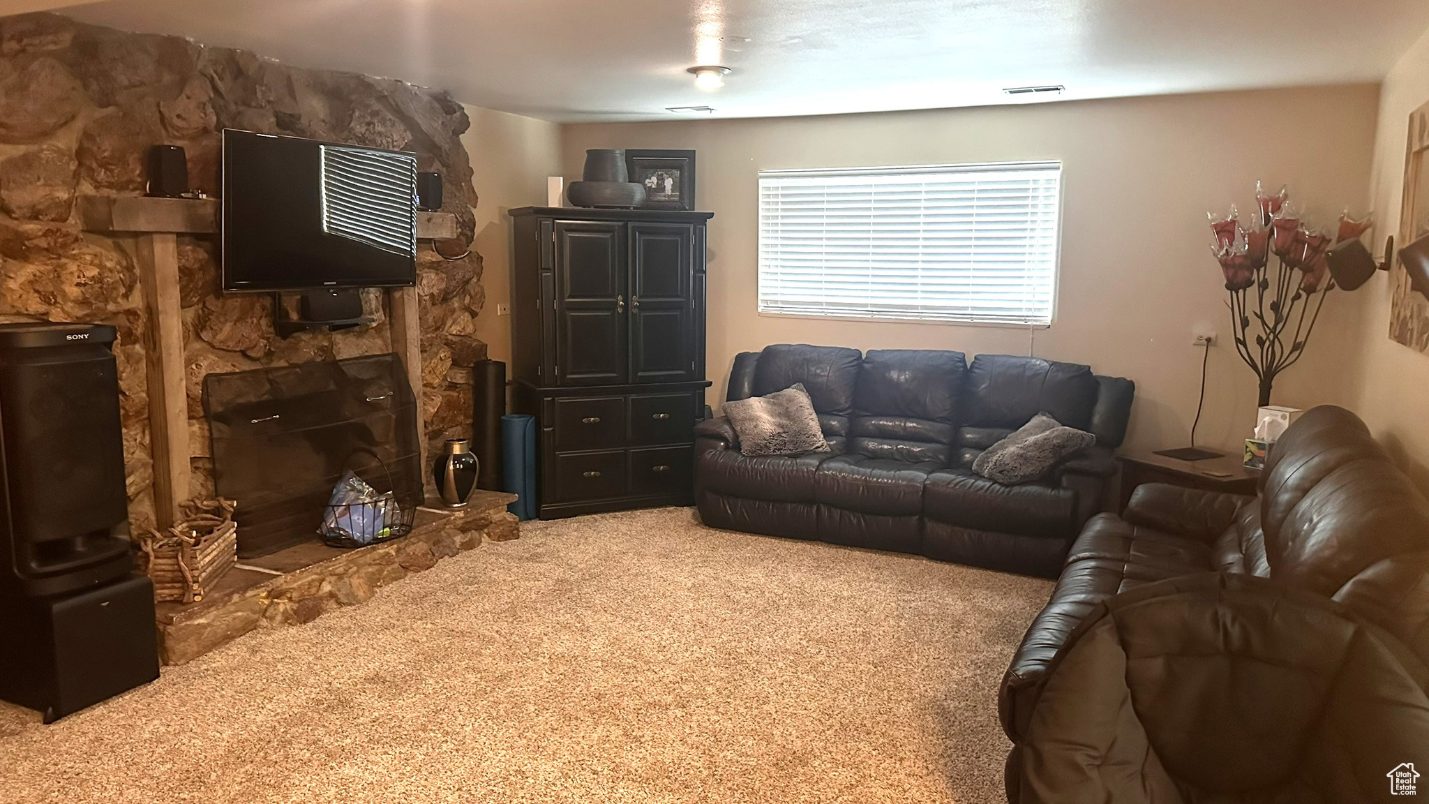 Carpeted living room featuring a fireplace