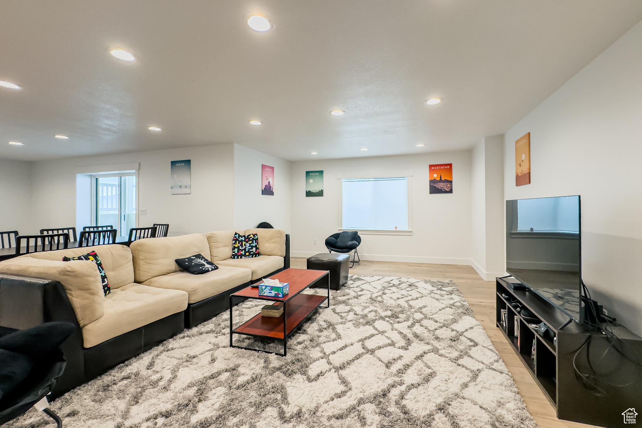 Living room with plenty of natural light and light hardwood / wood-style floors