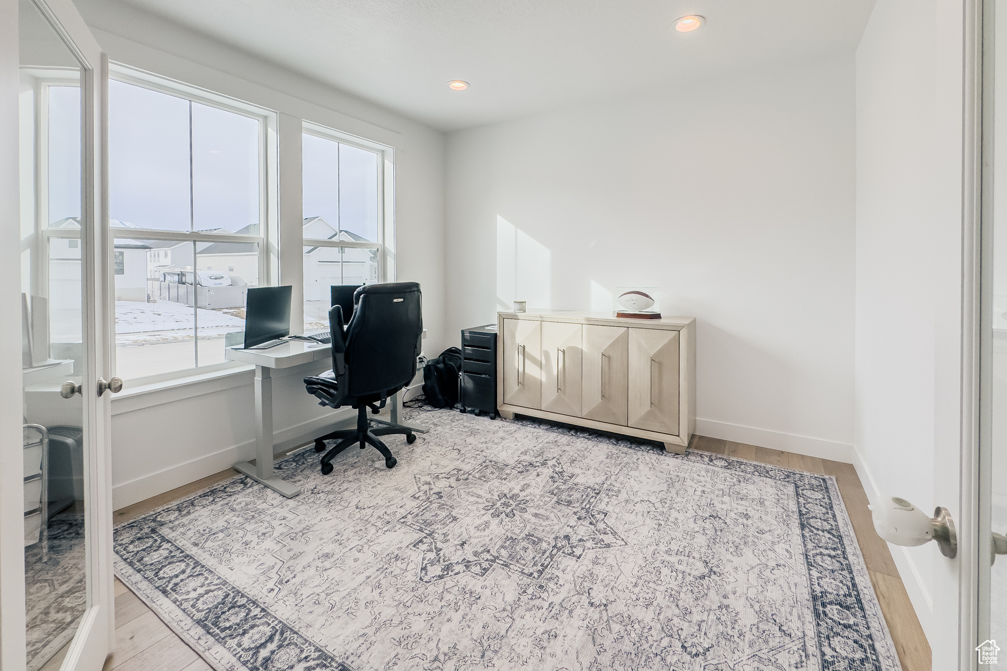 Office with light hardwood / wood-style floors