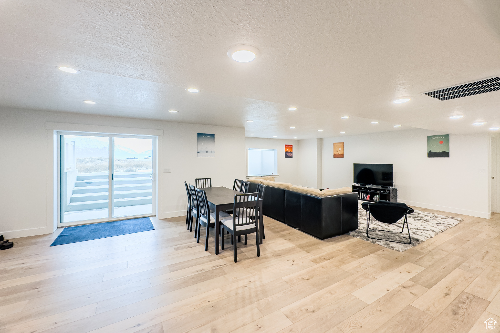 Dining room featuring light hardwood / wood-style flooring and a textured ceiling