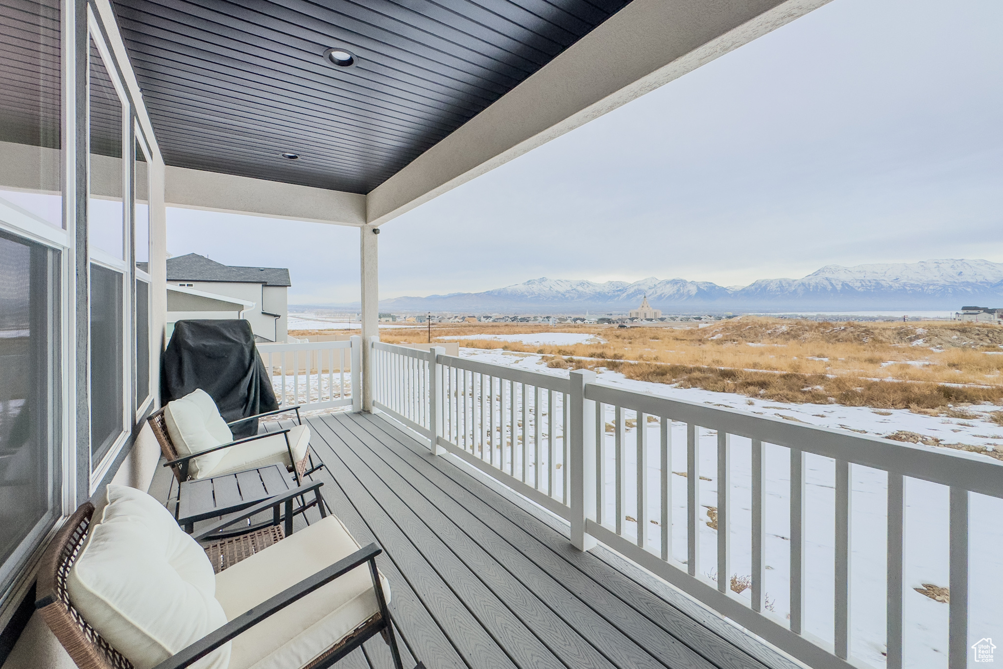 Snow covered deck with a mountain view