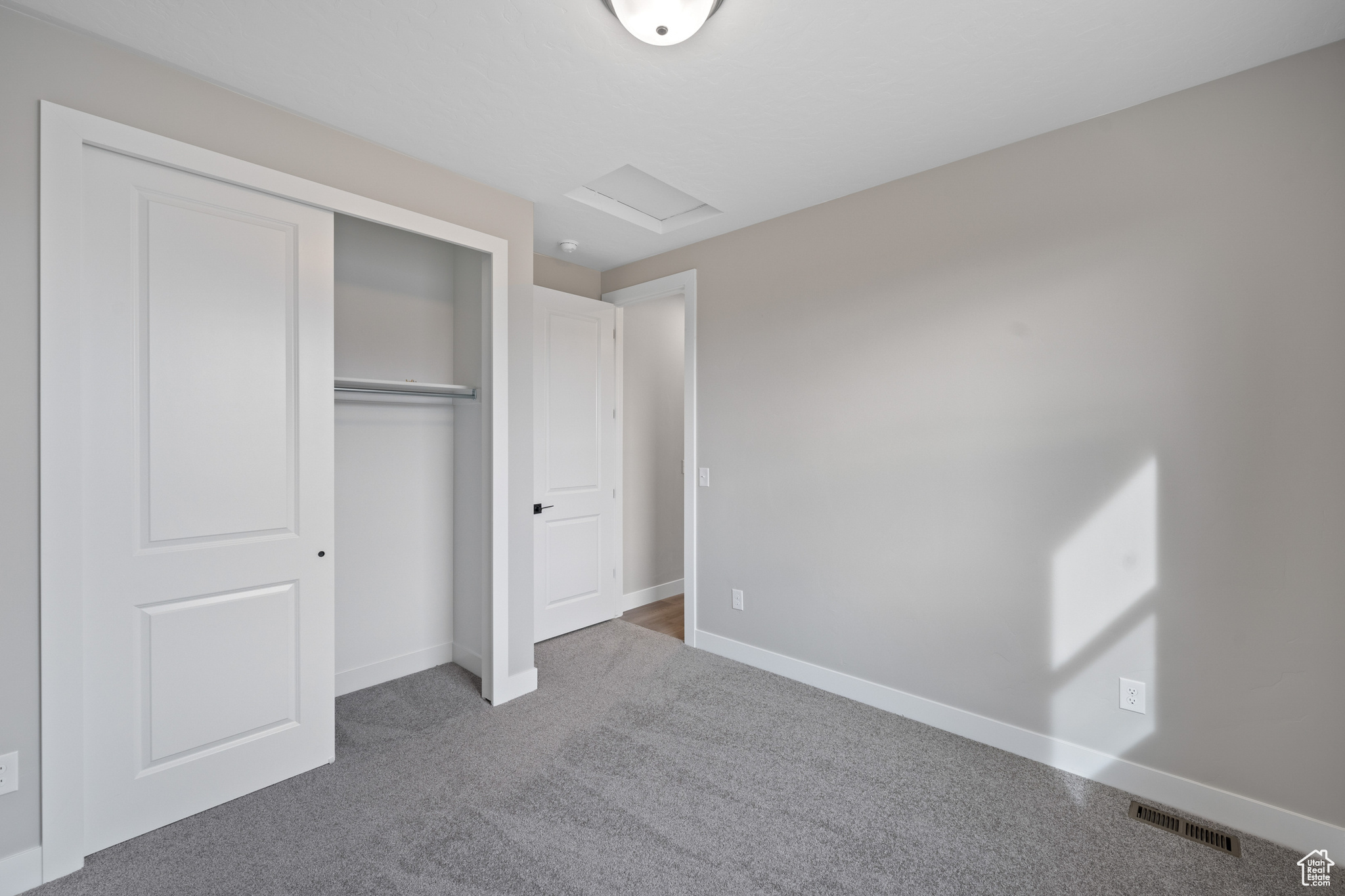 Unfurnished bedroom with carpet and a closet