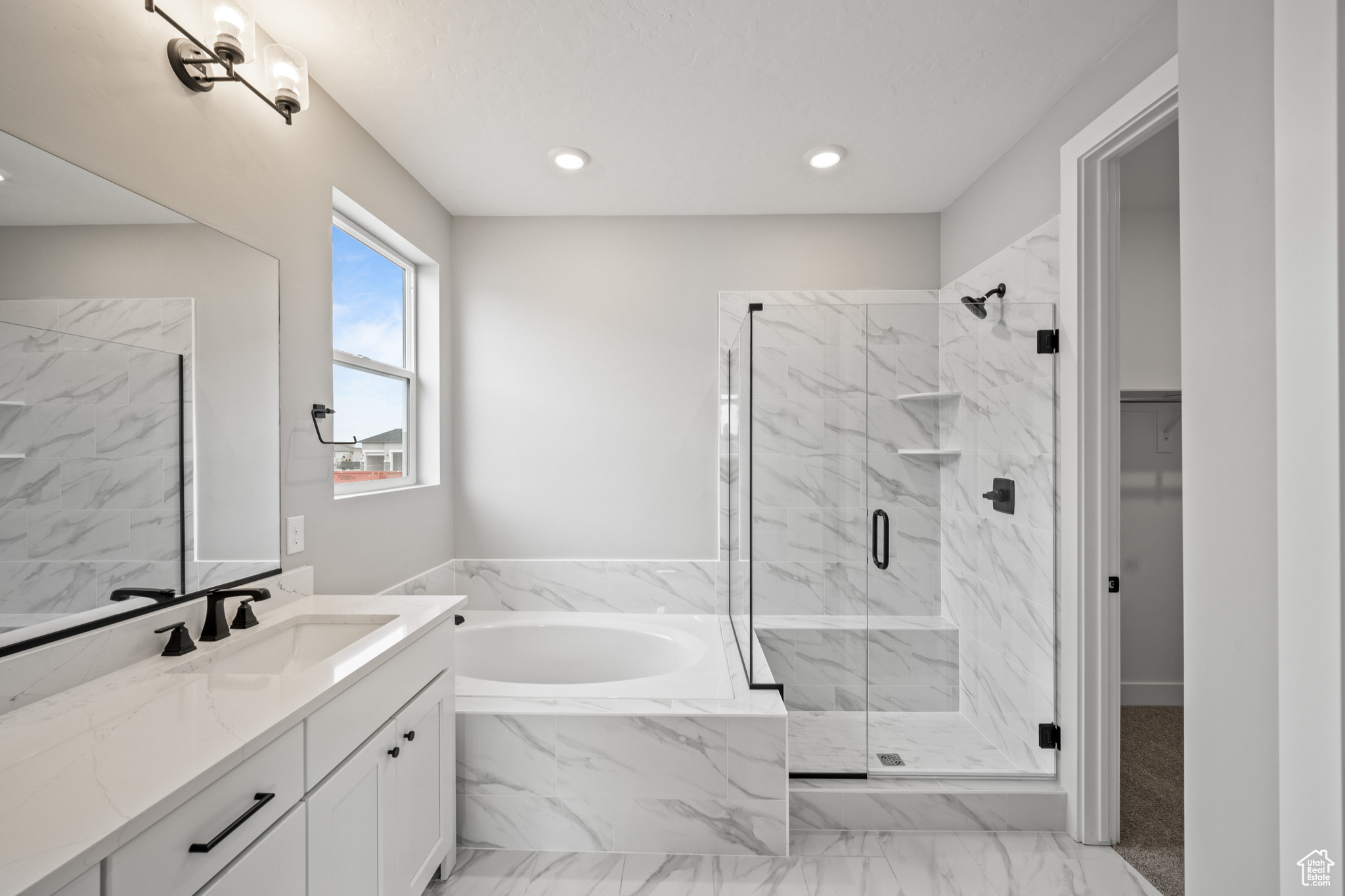 Bathroom featuring vanity and independent shower and bath