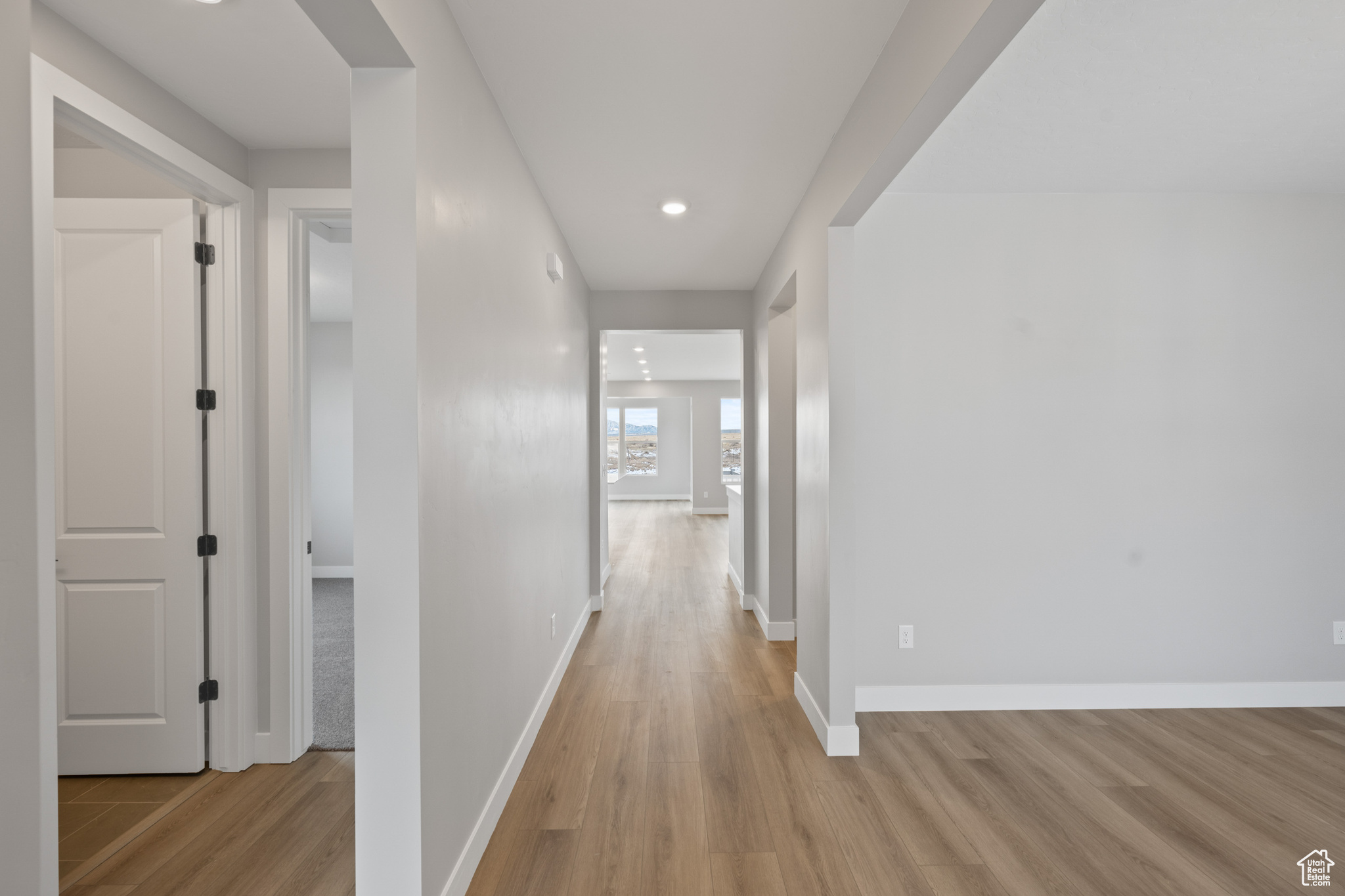 Hall with light hardwood / wood-style flooring