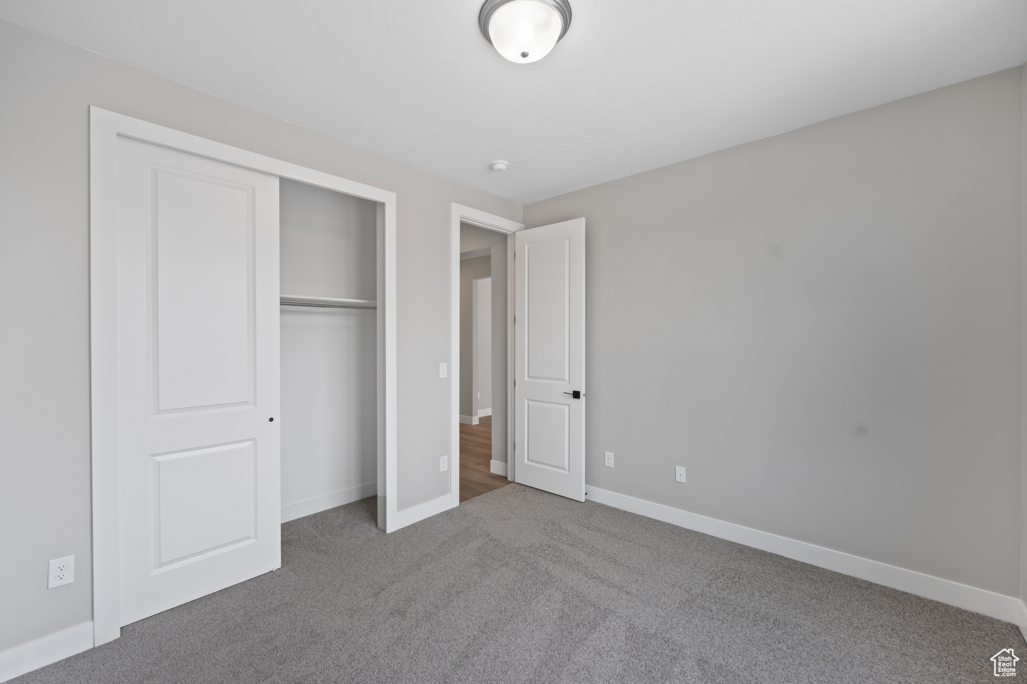 Unfurnished bedroom featuring a closet and carpet flooring