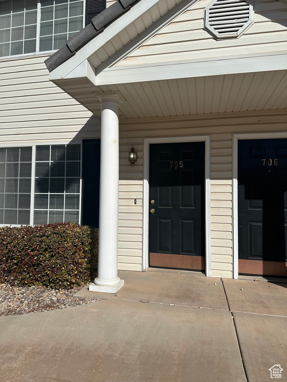 Doorway to property featuring covered porch