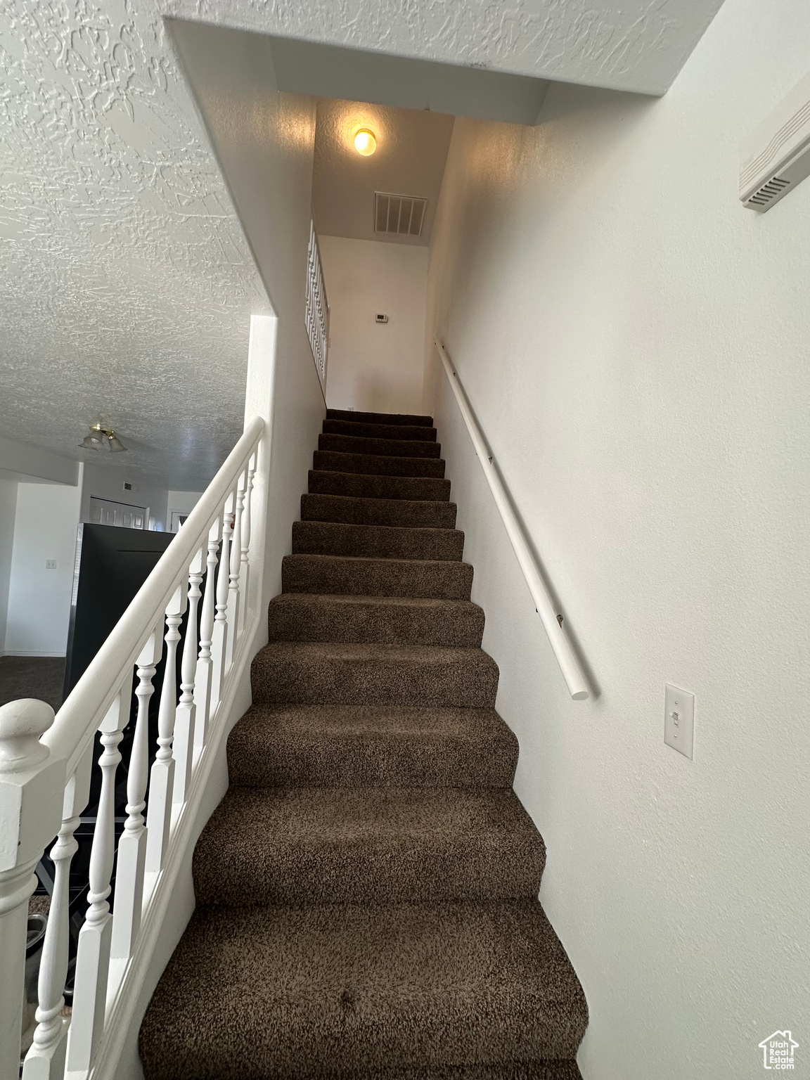 Stairway with a textured ceiling