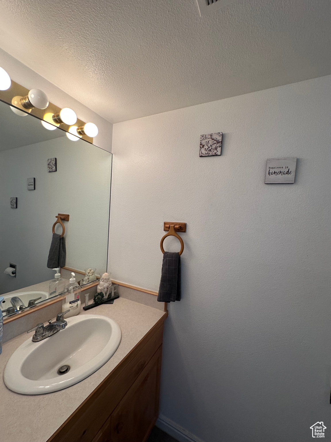 Bathroom with vanity and a textured ceiling