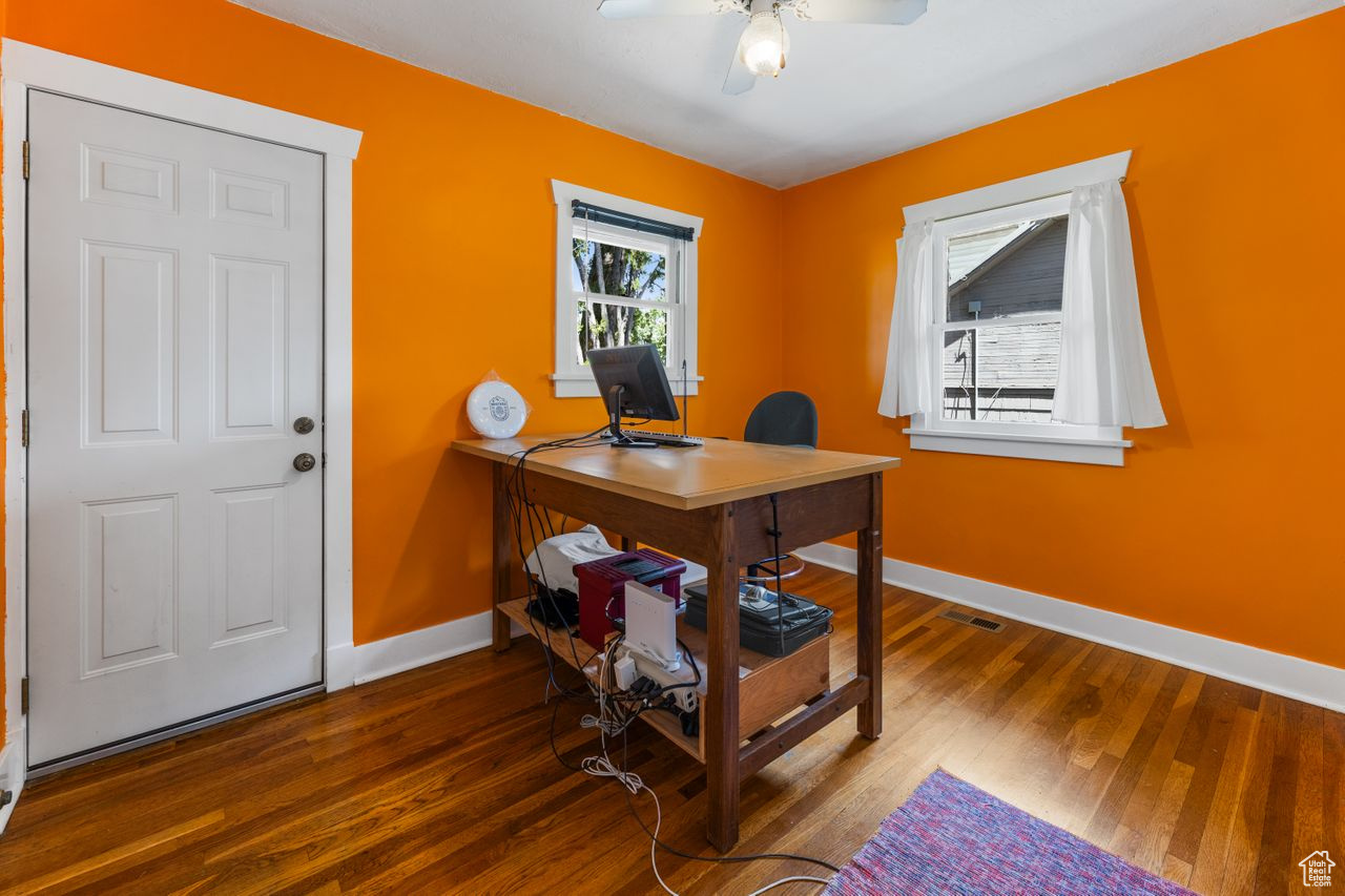 Office with ceiling fan and dark hardwood / wood-style floors