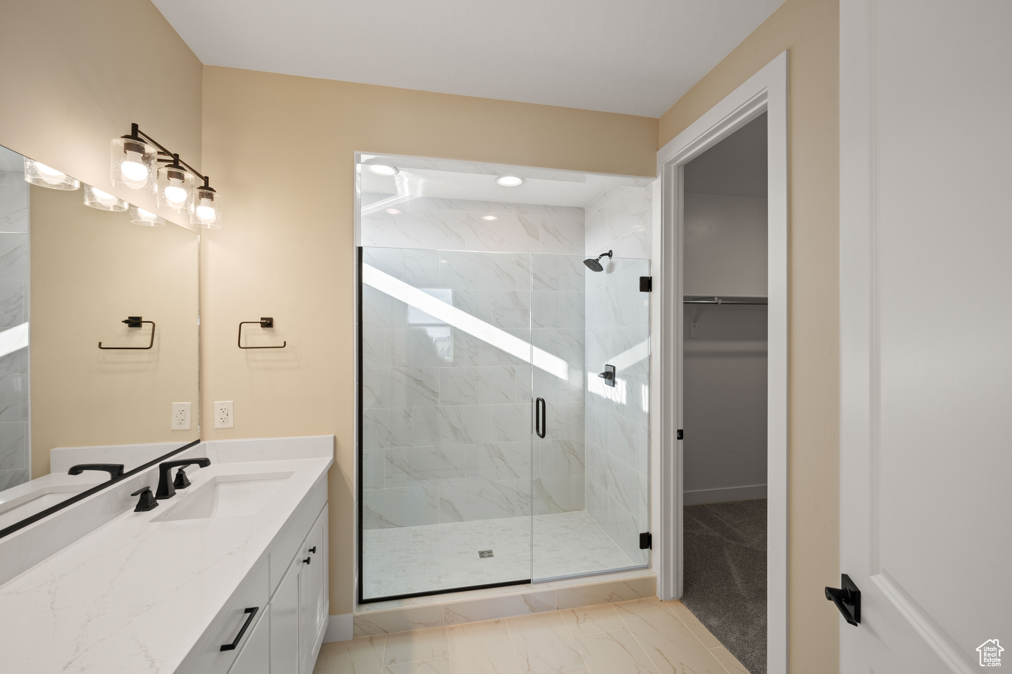 Bathroom with vanity and a shower with shower door