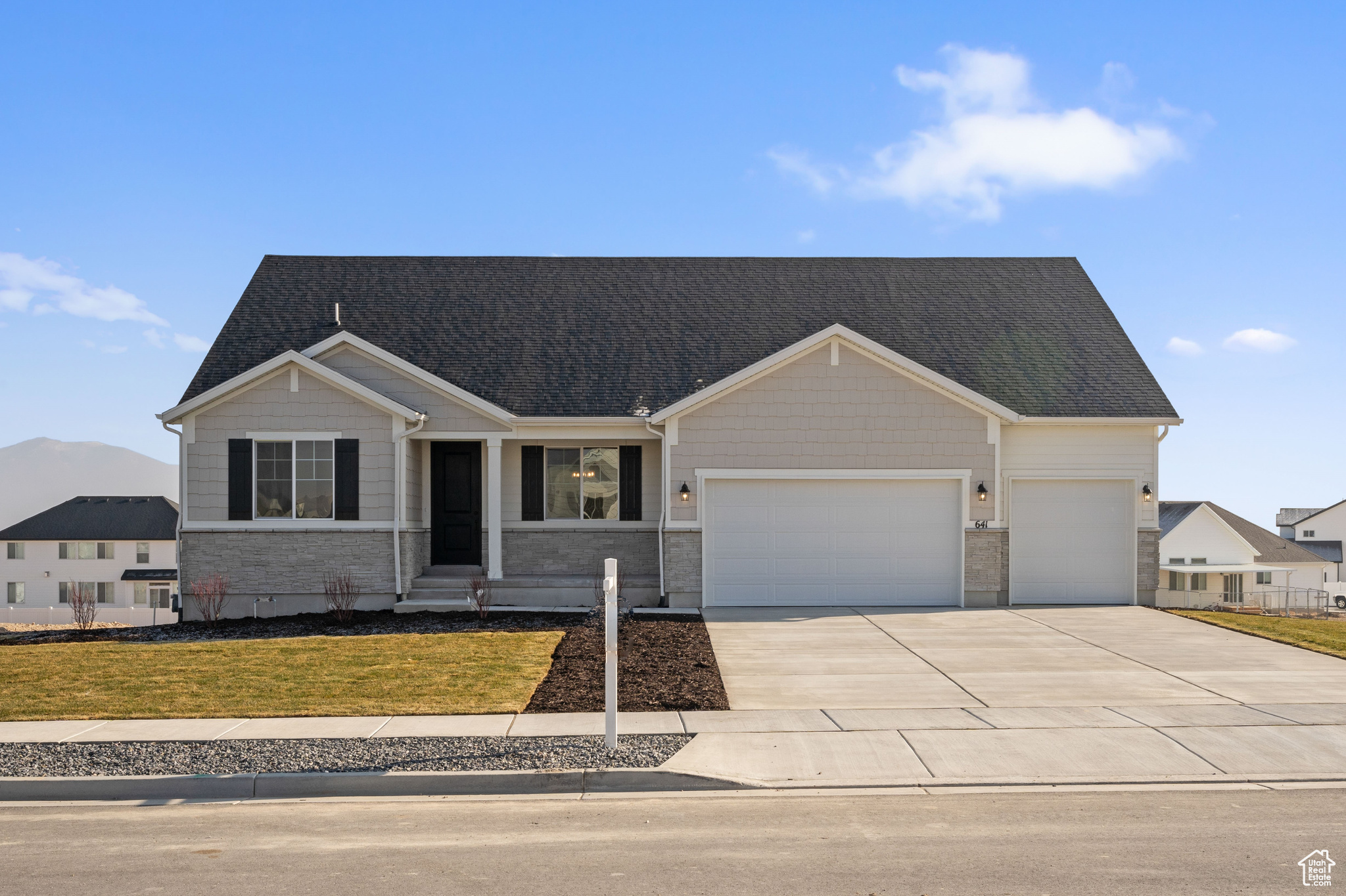 View of front of house with a garage and a front yard