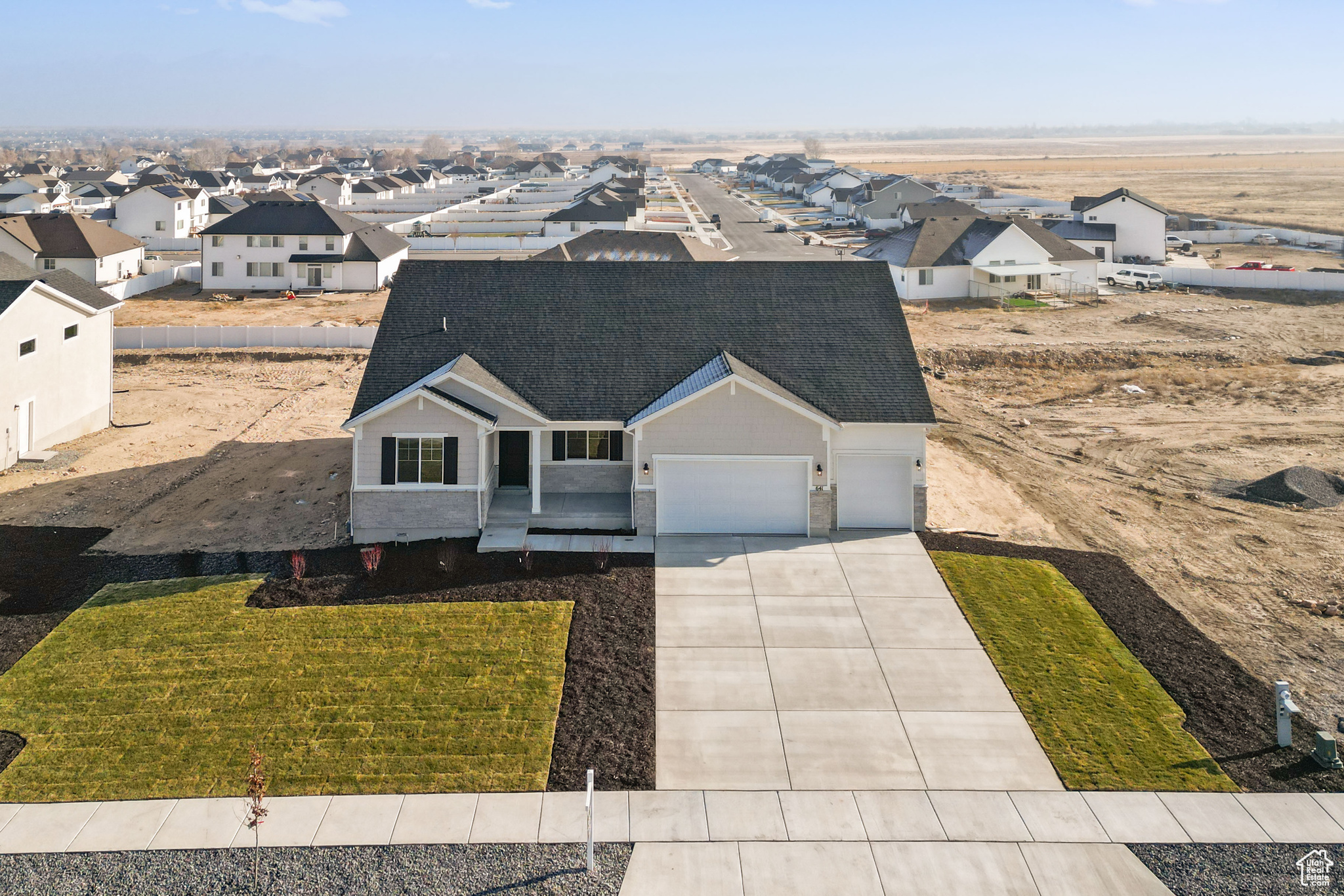 View of front of home with a garage and a front yard