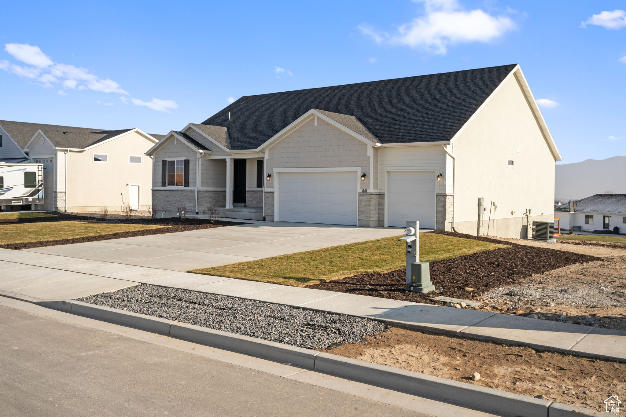 View of front of property with cooling unit and a garage