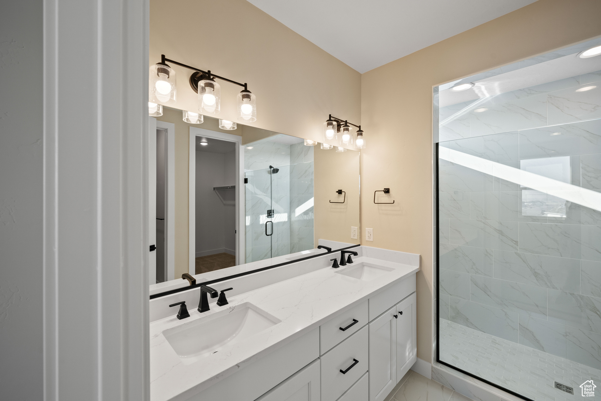 Bathroom with vanity and a shower with shower door