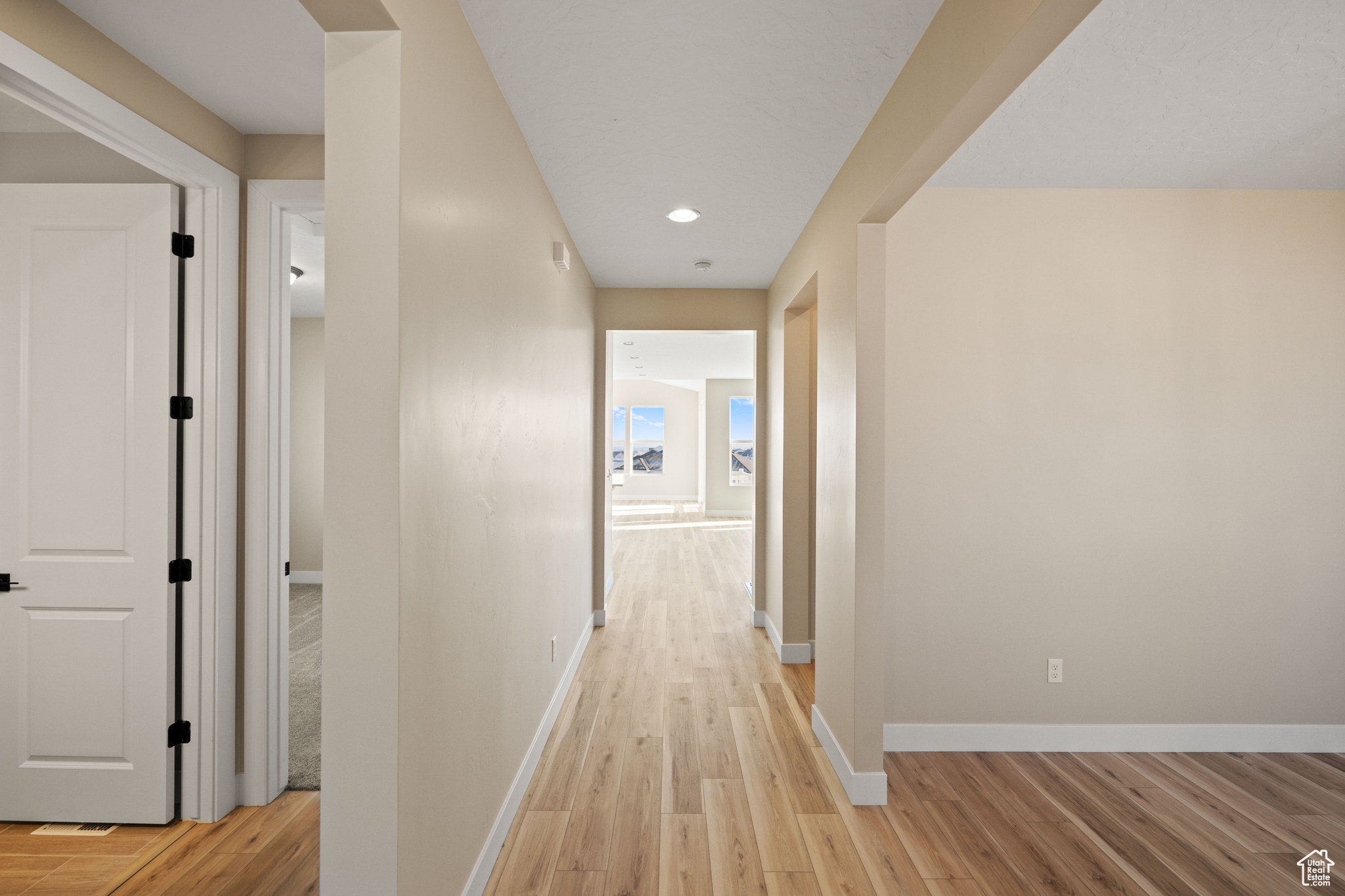 Corridor with light hardwood / wood-style floors