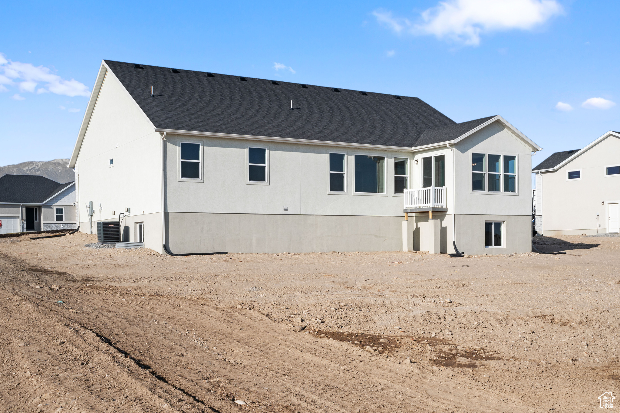 Rear view of property with central AC