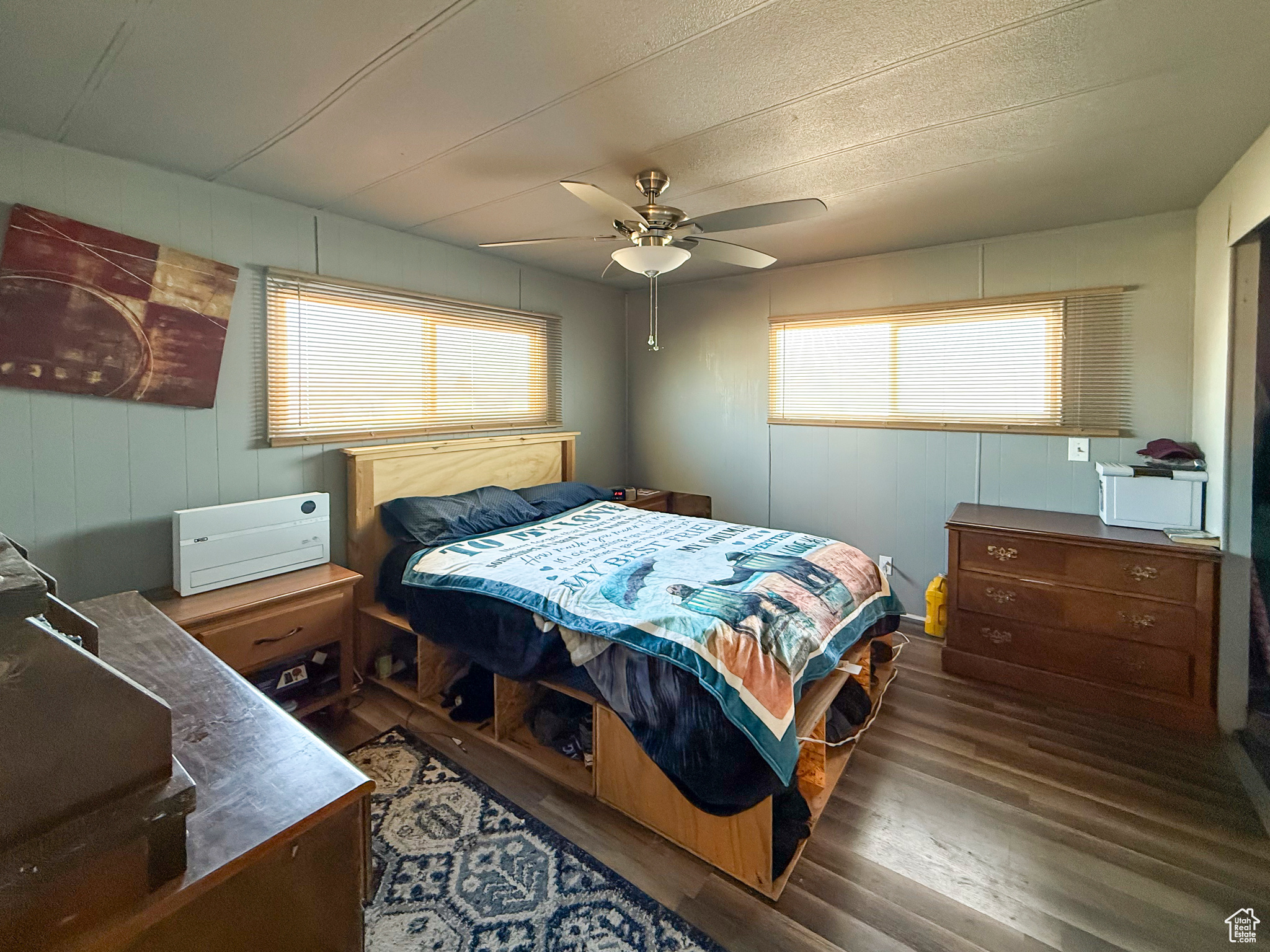 Bedroom with dark wood-type flooring and ceiling fan