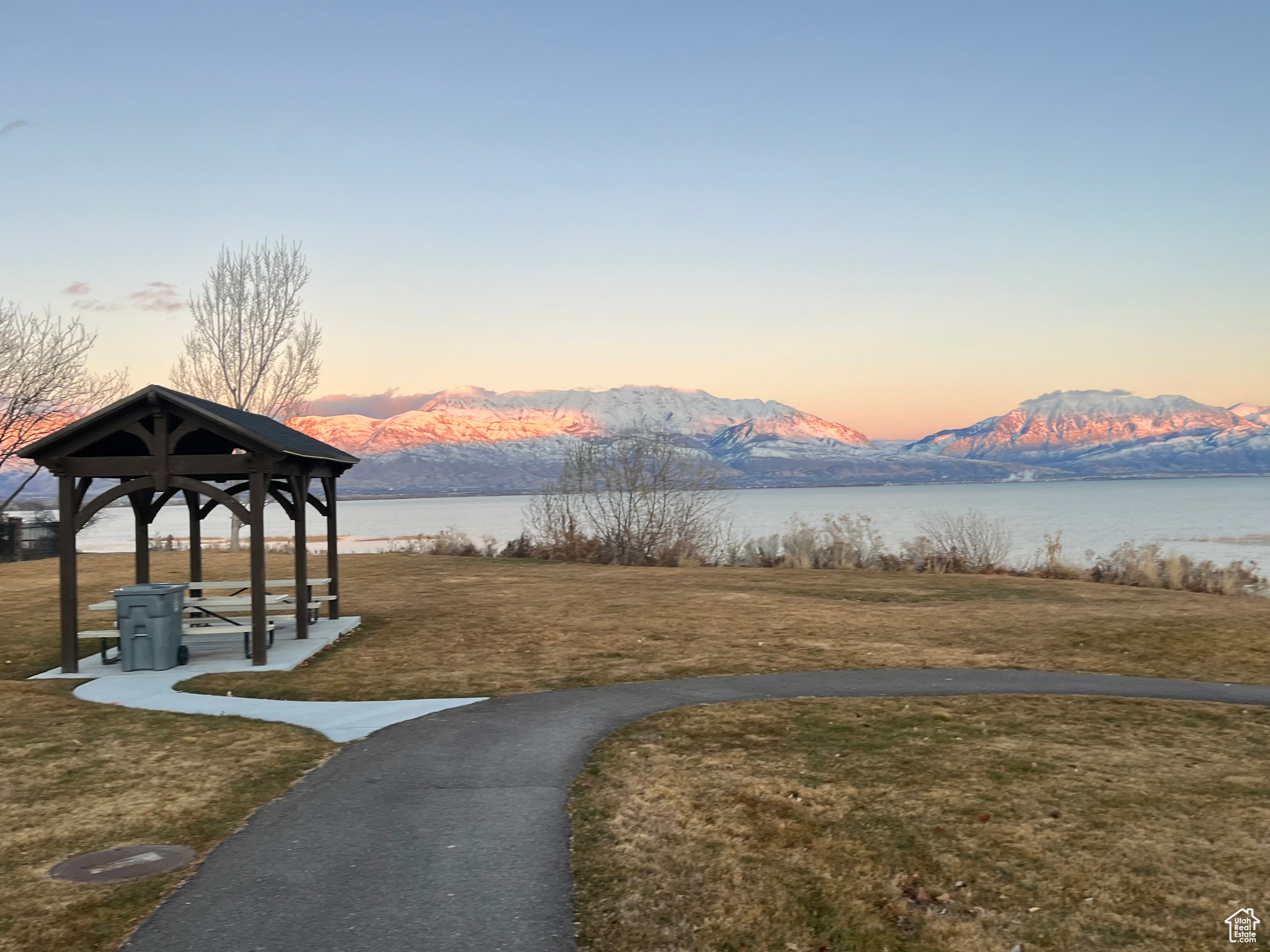 View of property's community featuring a water and mountain view, a gazebo, and a lawn