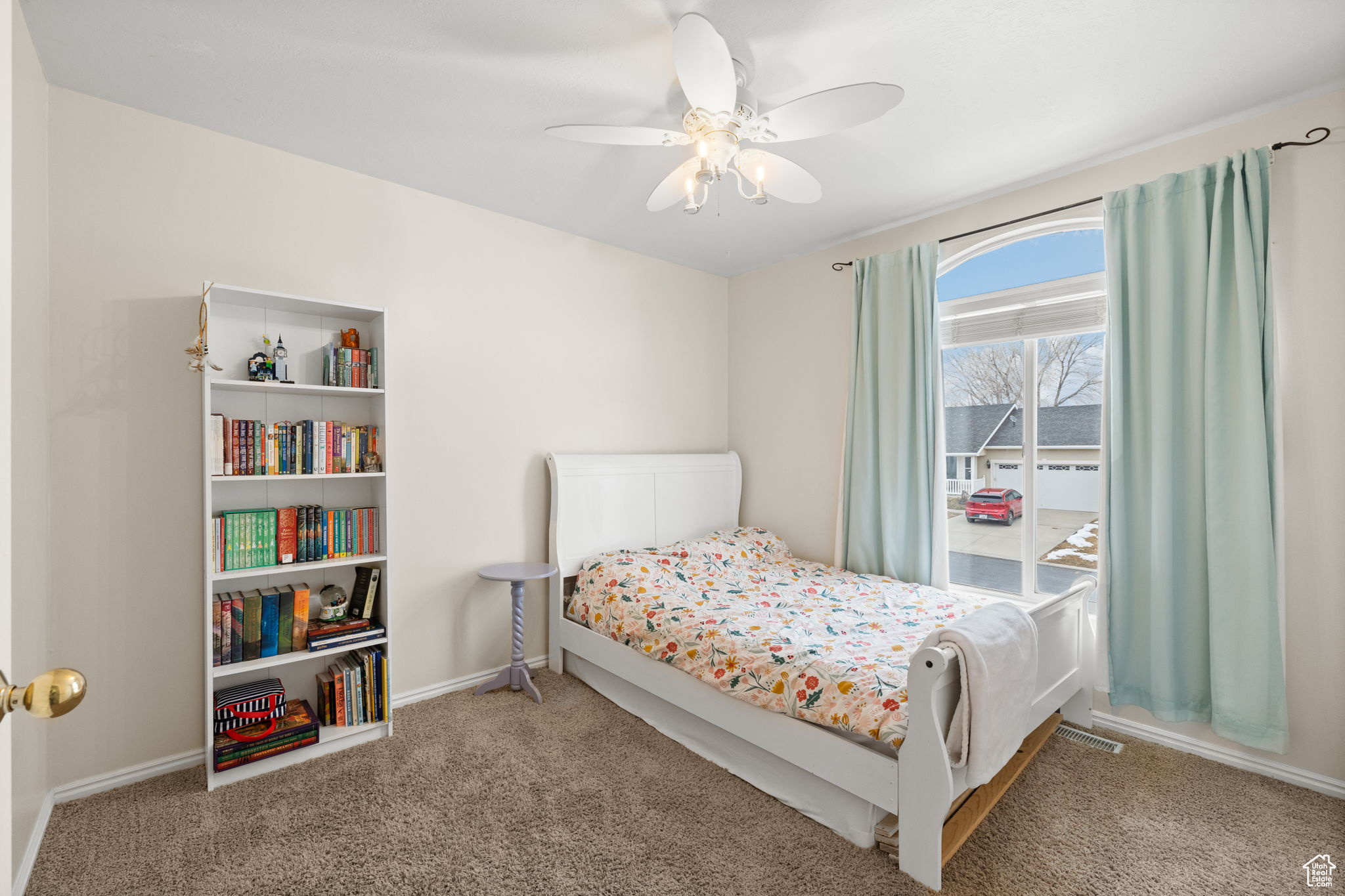 Carpeted bedroom with ceiling fan