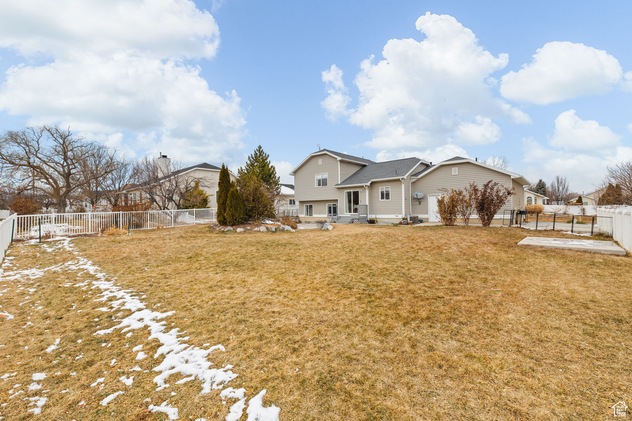 Rear view of house featuring a lawn