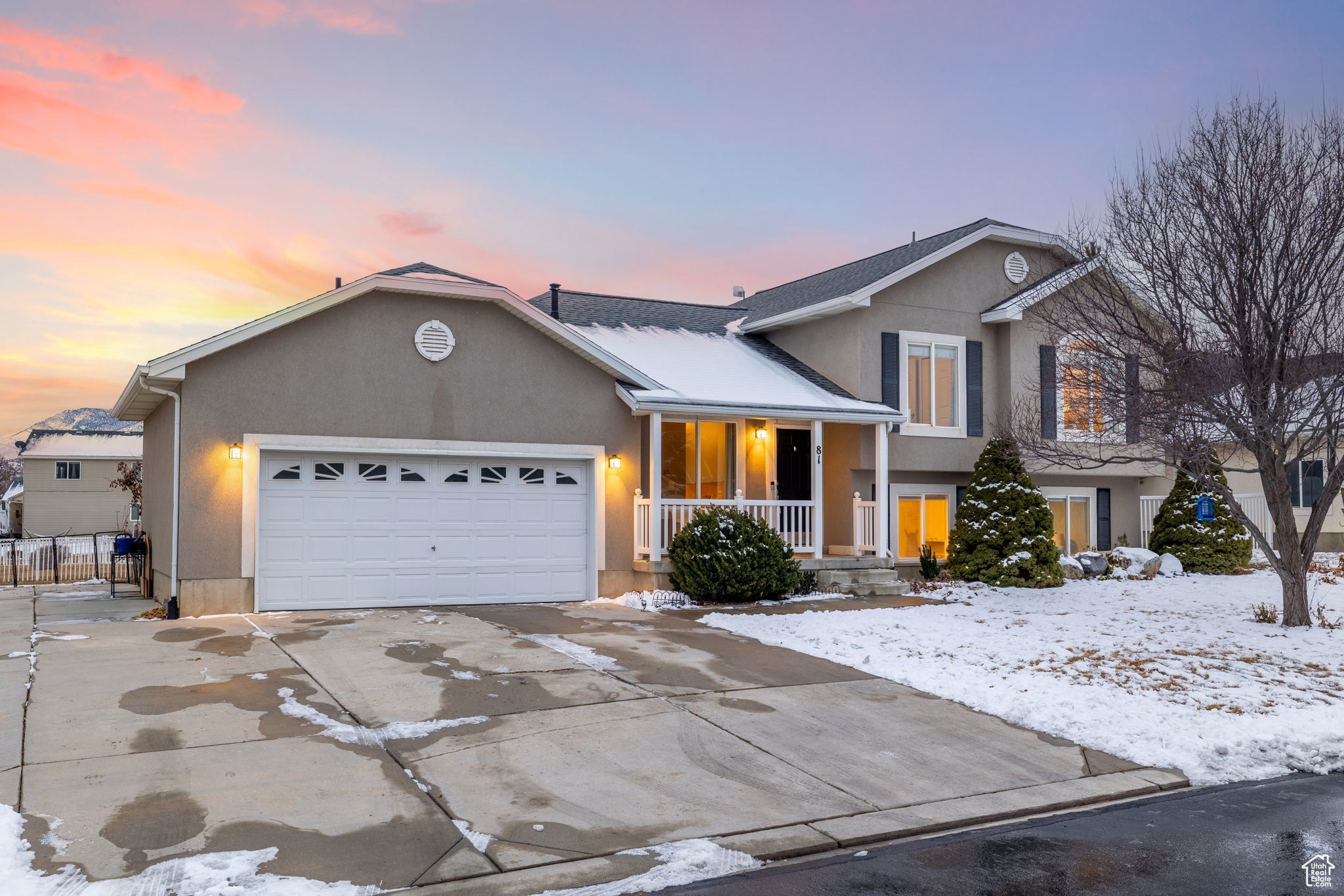 Split level home featuring a garage and covered porch