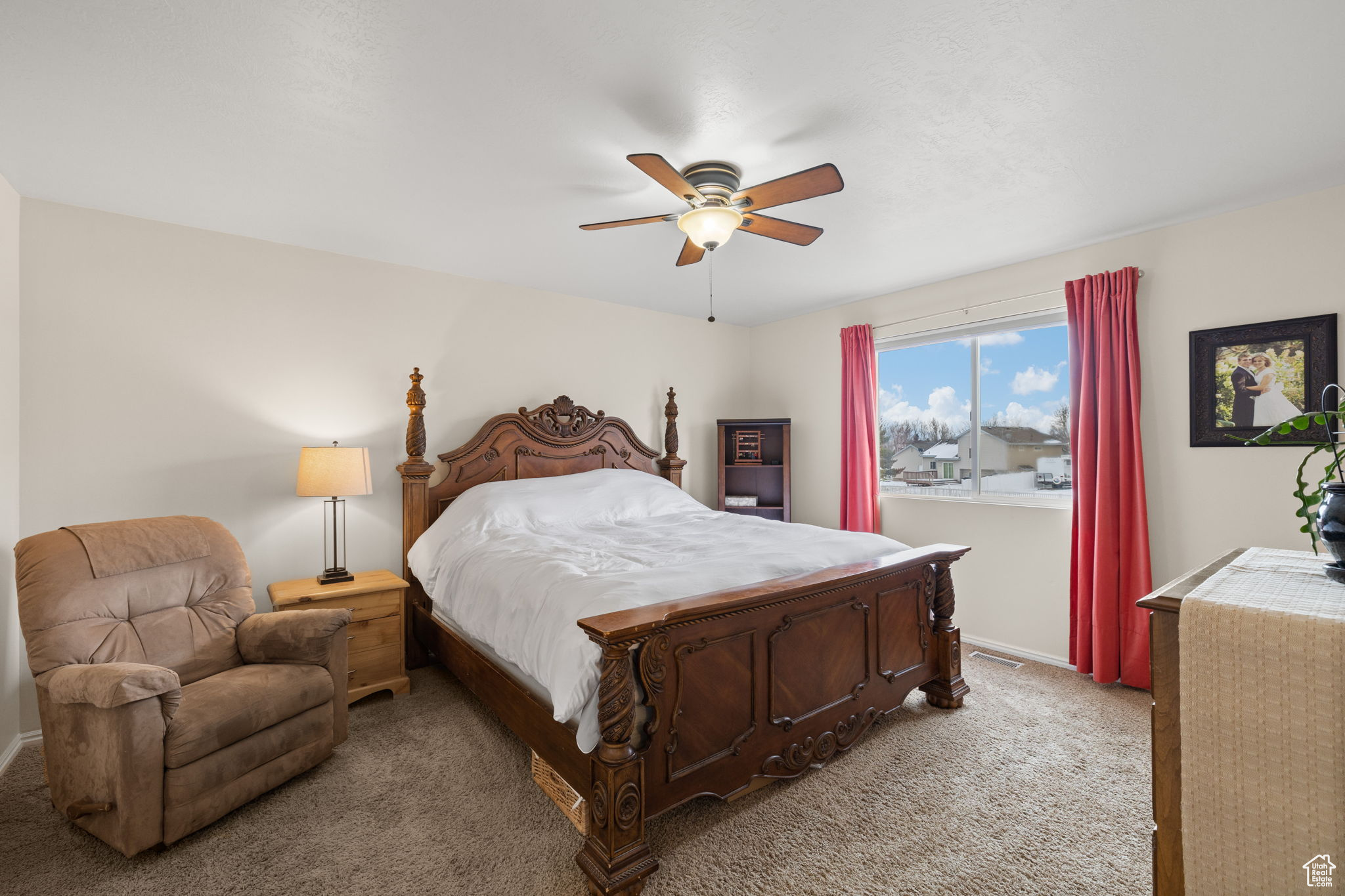 Bedroom with light colored carpet and ceiling fan