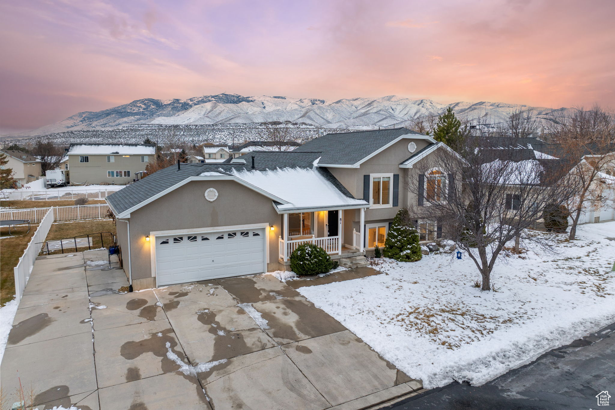 Front facade with a mountain view, a garage, and a porch