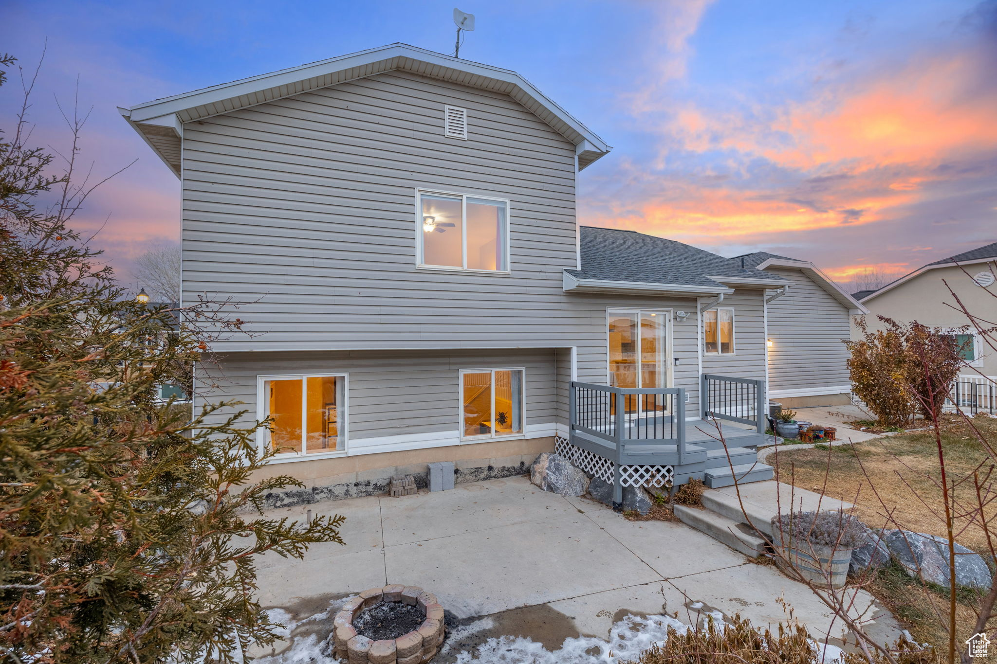 Back house at dusk featuring a patio area