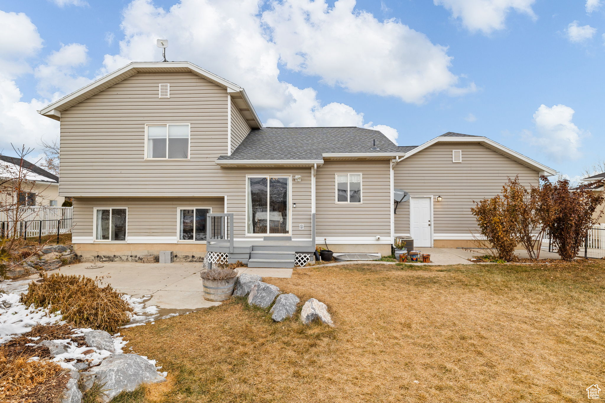 Rear view of property featuring a patio area and a lawn