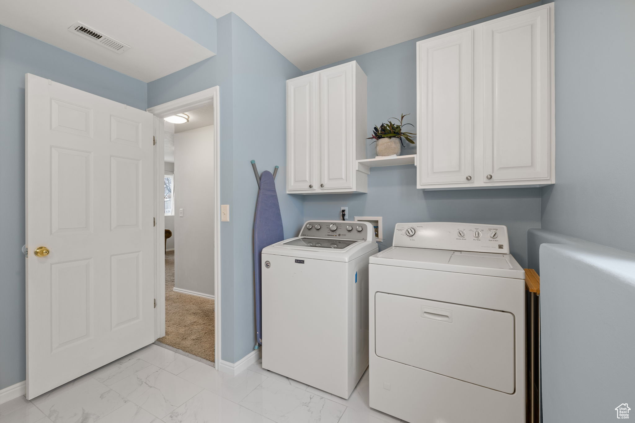 Laundry room featuring cabinets and washing machine and clothes dryer