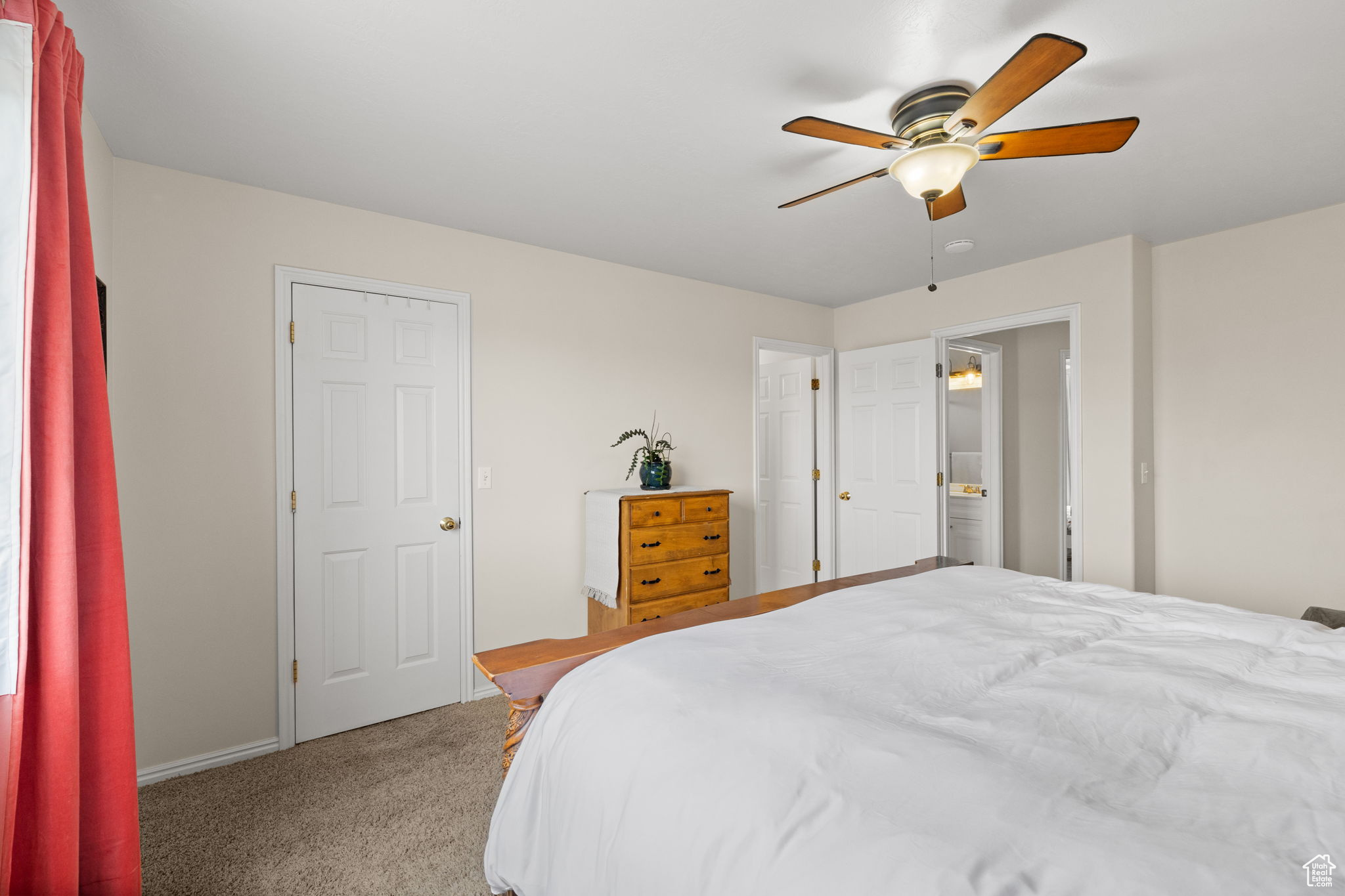 Carpeted bedroom featuring ceiling fan