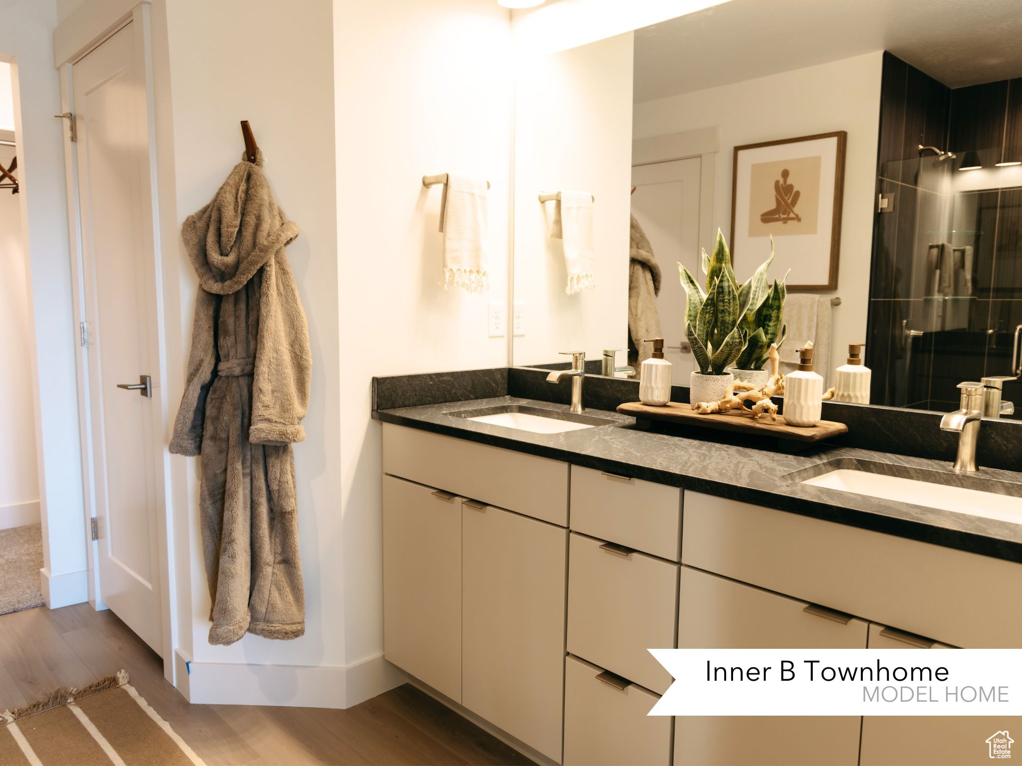 Bathroom featuring hardwood / wood-style flooring, vanity, and an enclosed shower