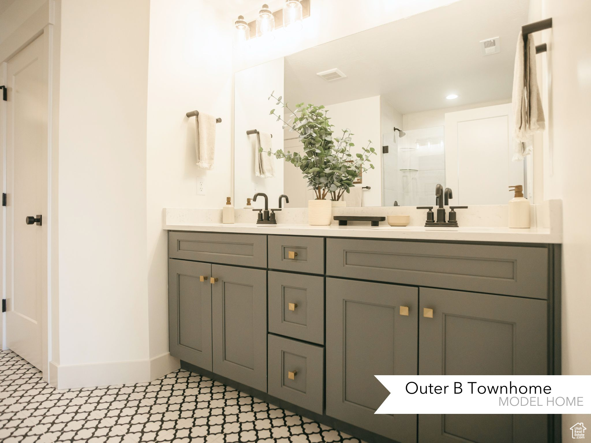 Bathroom with vanity and a shower with door