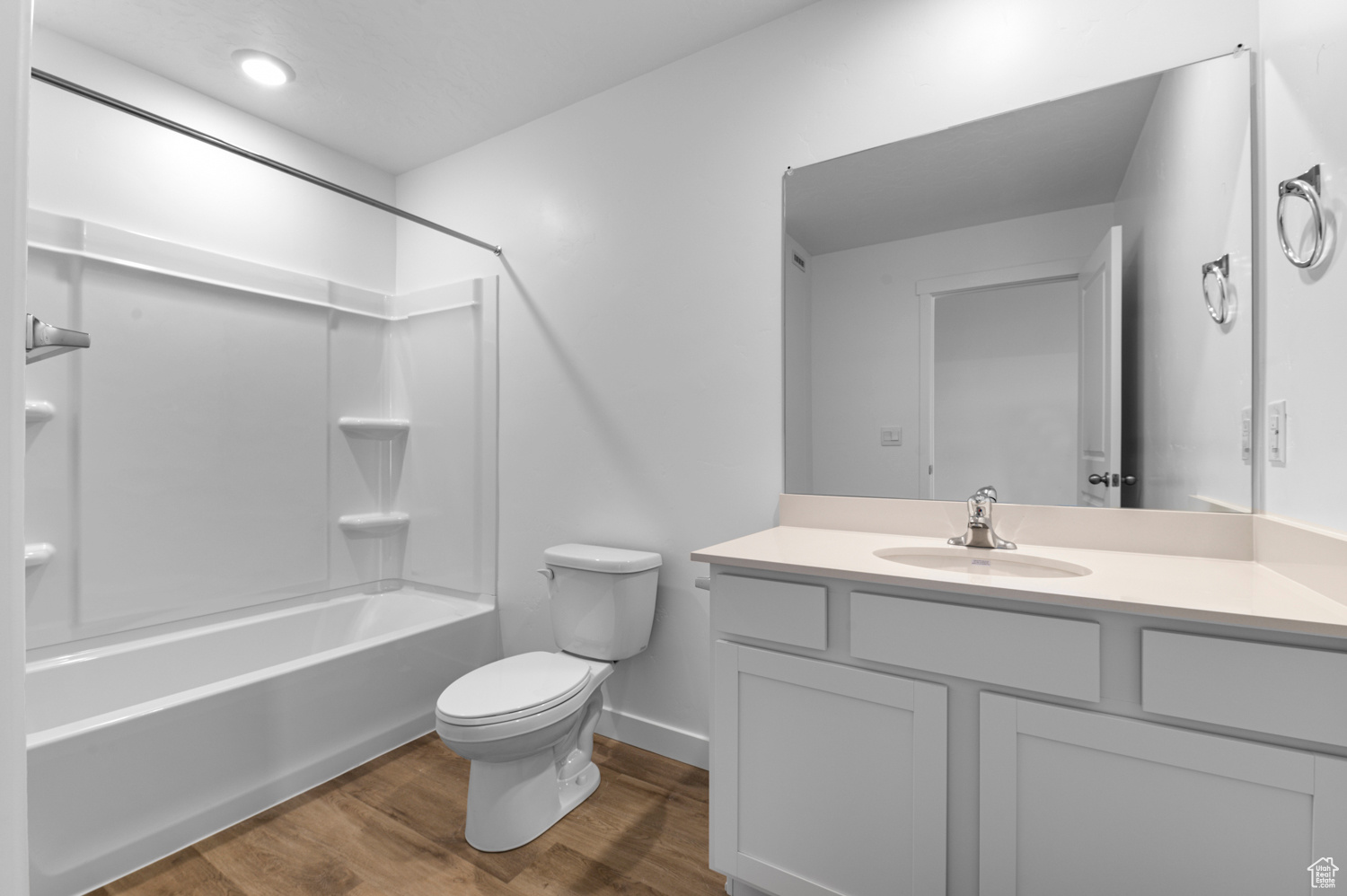 Full bathroom featuring vanity, hardwood / wood-style floors, toilet, and shower / bathing tub combination