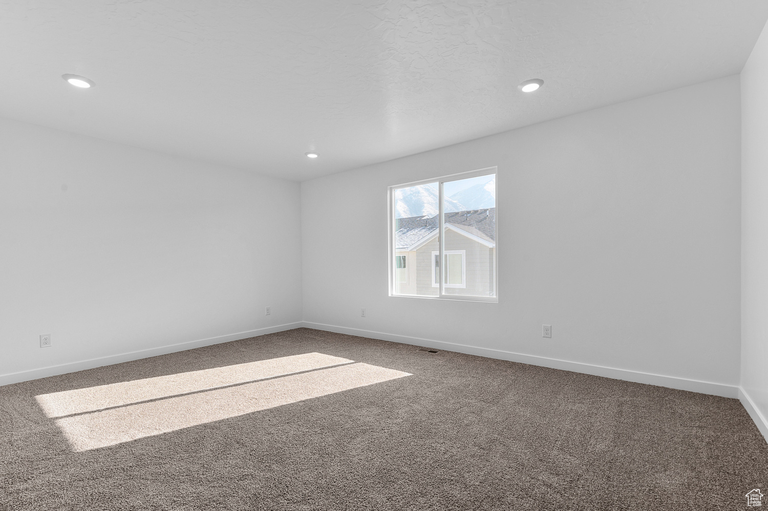 Spare room featuring carpet flooring